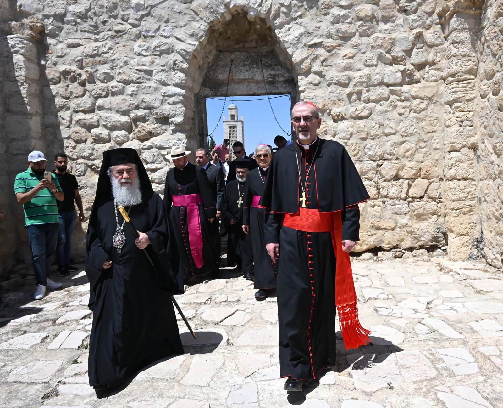 Cardinal Pierbattista Pizzaballa, the Latin patriarch of Jerusalem, and Greek Orthodox Patriarch Theophilos III of Jerusalem, enter the fifth-century St. George Church, during a solidarity visit with the patriarchs and heads of churches of Jerusalem to the Palestinian Christian town of Taybeh, West Bank, July 14, 2025. The visit was in response to the July 7 attack when radical Israeli settlers set fire near the village cemetery and the church. (OSV News photo/Debbie Hill)