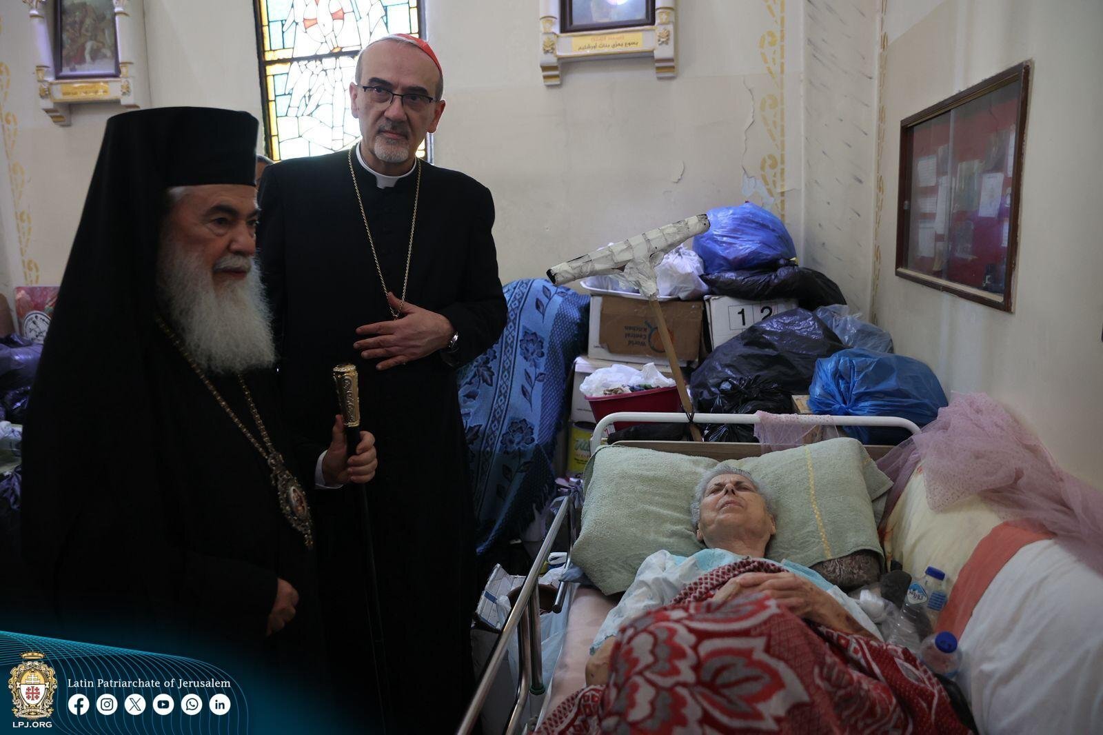 Latin Patriarch of Jerusalem Cardinal Pierbattista Pizzaballa, who entered the Gaza Strip with Greek Orthodox Patriarch of Jerusalem Theophilos III, is seen on a July 18, 2025 photo on the premises of Holy Family Parish in Gaza City, visitng an elderly parishioner. The patriarchs offered support, closeness and prayers following the Israeli military strike on the Holy Family Parish compound in Gaza City, which killed three people and wounded ten, including parish pastor Father Gabriel Romanelli, on July 17. (OSV News photo/courtesy Latin Patriarchate of Jerusalem)