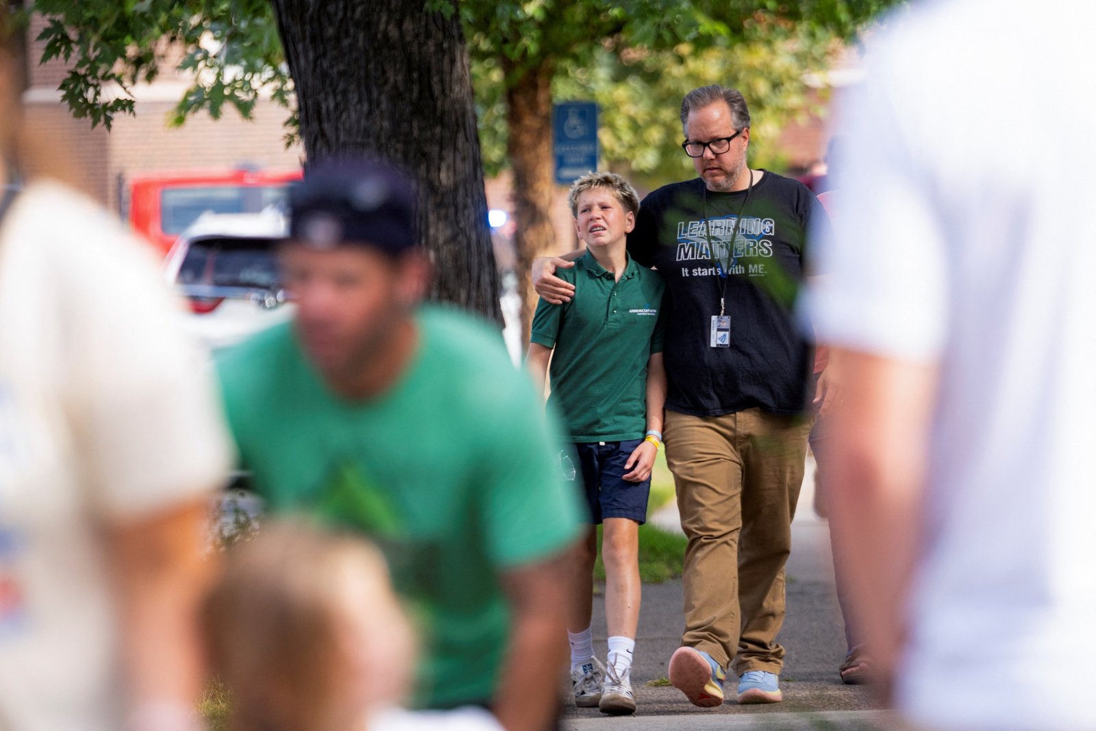 Families and loved ones walk outside the police barricades following a shooting at Annunciation Catholic School in Minneapolis Aug. 27, 2025. The Richfield Police Department is reporting there are up to 20 victims; two children and the suspected shooter are dead. (OSV News photo/Ben Brewer, Reuters)