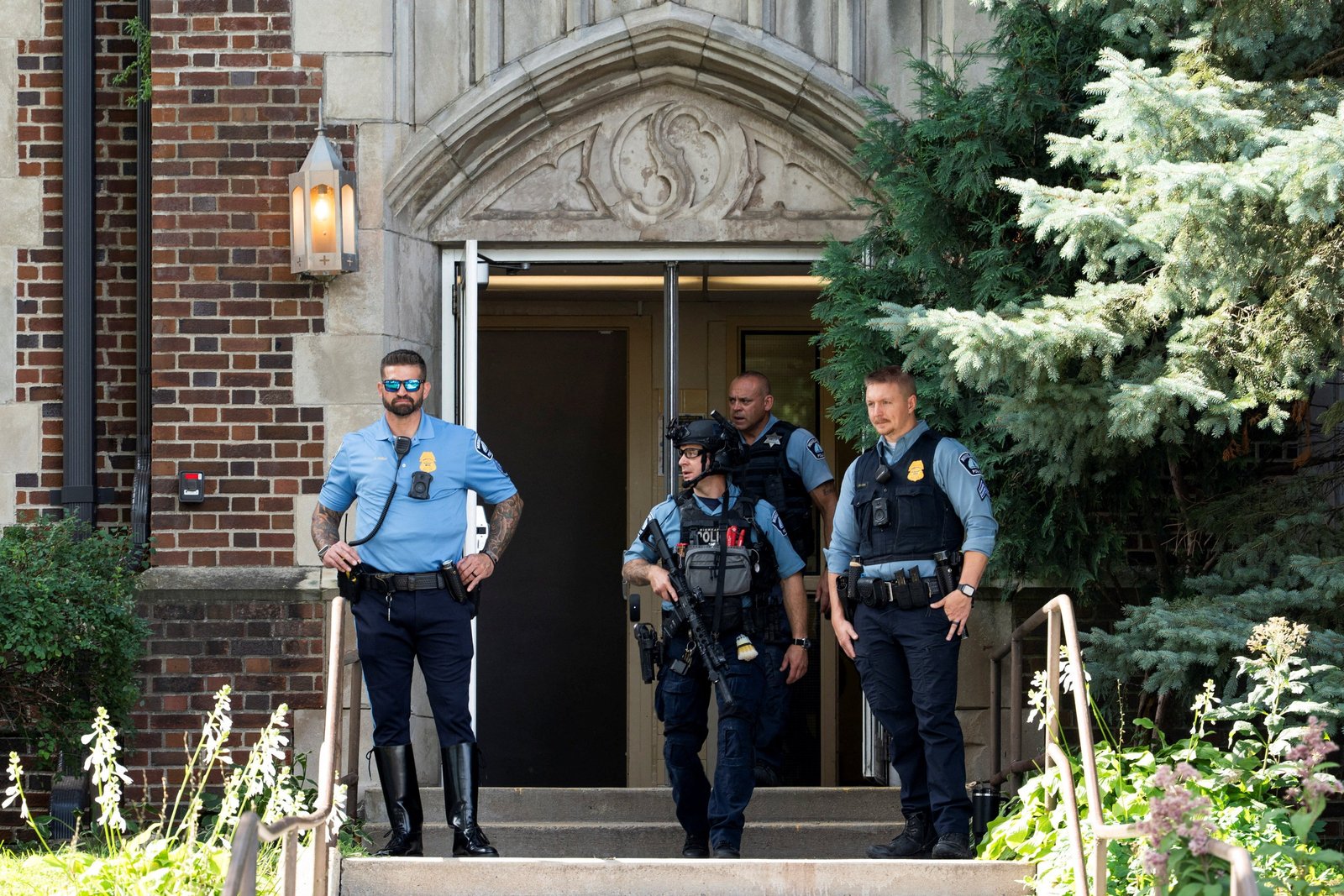 Following a shooting, first responders stand at the entrance to Annunciation Catholic School in Minneapolis Aug. 27, 2025. A shooter opened fire with a rifle through the windows of a the school church and struck children celebrating Mass during the first week of school, killing two and wounding 17 people in an act of violence the police chief called “absolutely incomprehensible.” (OSV News photo/Tim Evans, Reuters)