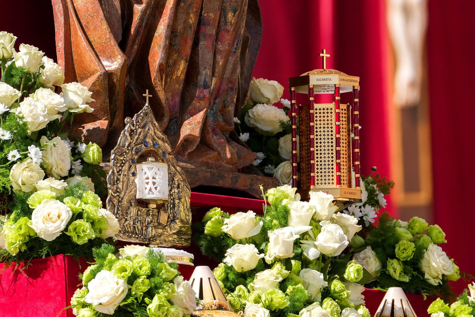 Reliquaries containing the relics of St. Carlo Acutis and St. Pier Giorgio Frassati stand at the foot of a statue of Mary during the canonization Mass celebrated by Pope Leo XIV in St. Peter’s Square at the Vatican Sept. 7, 2025. (CNS photo/Lola Gomez)