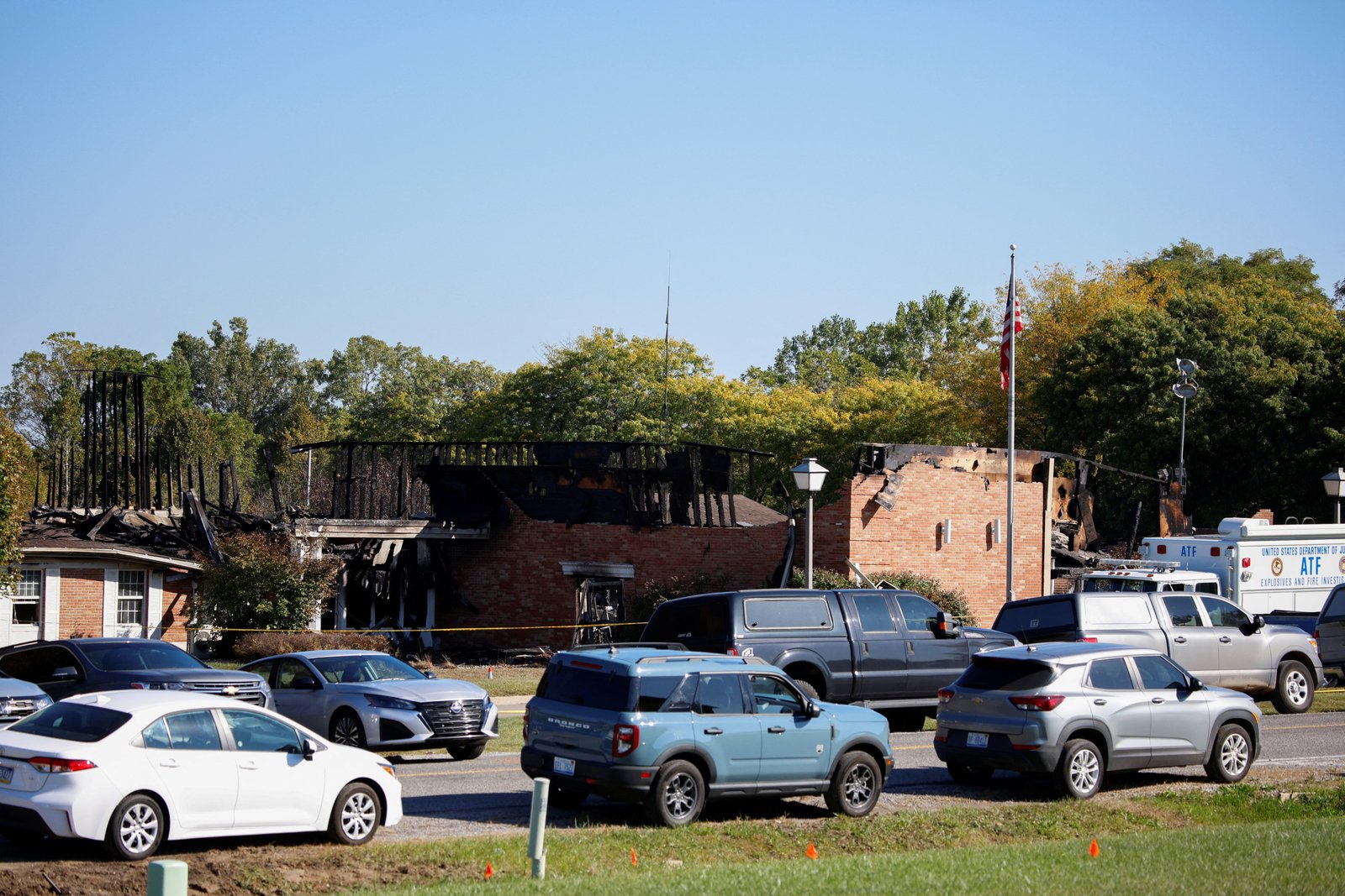 Vehicles are parked near the remains of the burned Church of Jesus Christ of Latter-day Saints, following a mass shooting, in Grand Blanc, Mich., Sept. 29, 2025. (OSV News photo/Rebecca Cook, Reuters)