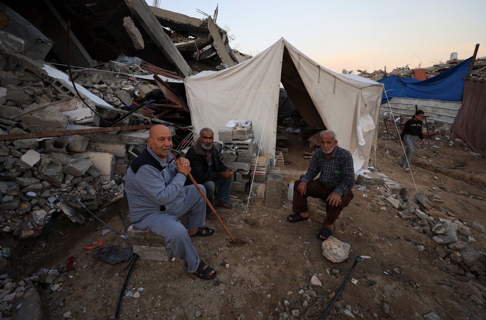 Palestinians sit near a tent that stands next to debris, amid a ceasefire between Israel and Hamas, in Gaza City, Nov. 17, 2025. (OSV News photo/Dawoud Abu Alkas, Reuters)
