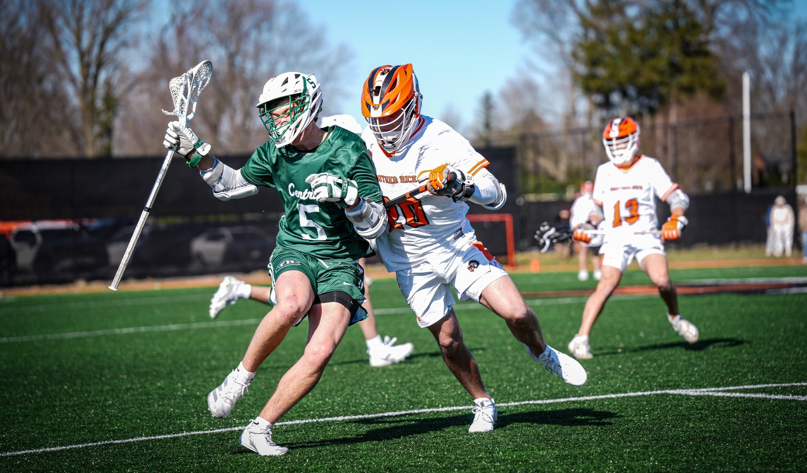 Brother Rice senior midfielder Thomas Brady (in white) and Grand Rapids Forest Hills Central’s Henry McNamara compete for an advantage in typical lacrosse action. Rice won the game, 9-7.