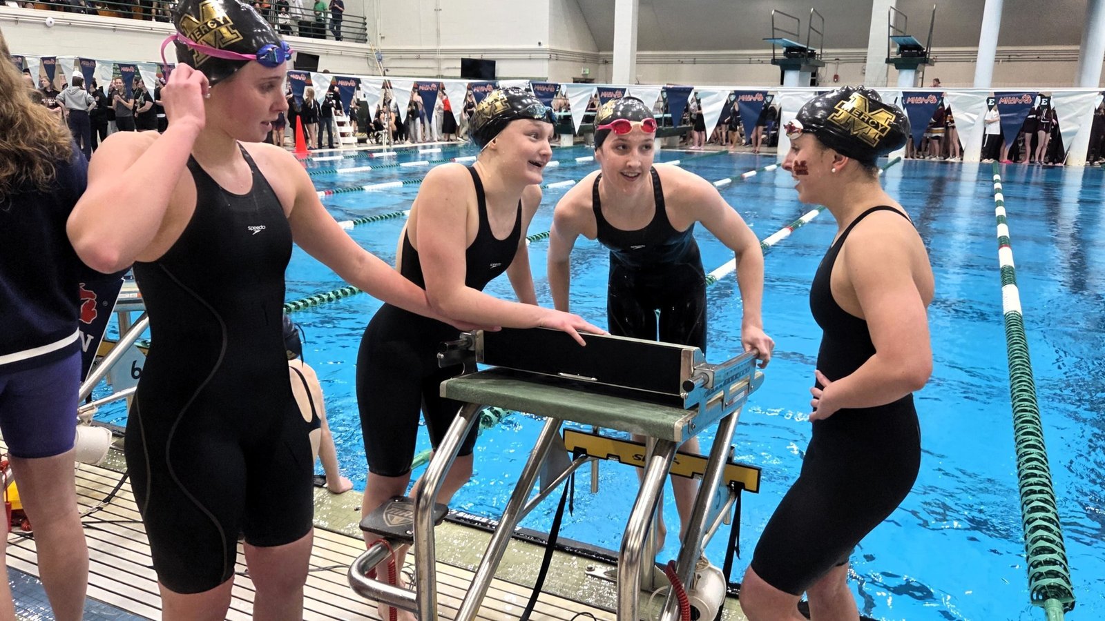 Avery Tack, Campbell Shore, Ella Hafner and Lyla Collins take in the moment after winning the meet’s final relay to win the state Division 2 championship by just two points for Mercy. It was the Marlins' third-straight state title and 14th championship overall. (Wright Wilson | Special to Detroit Catholic)