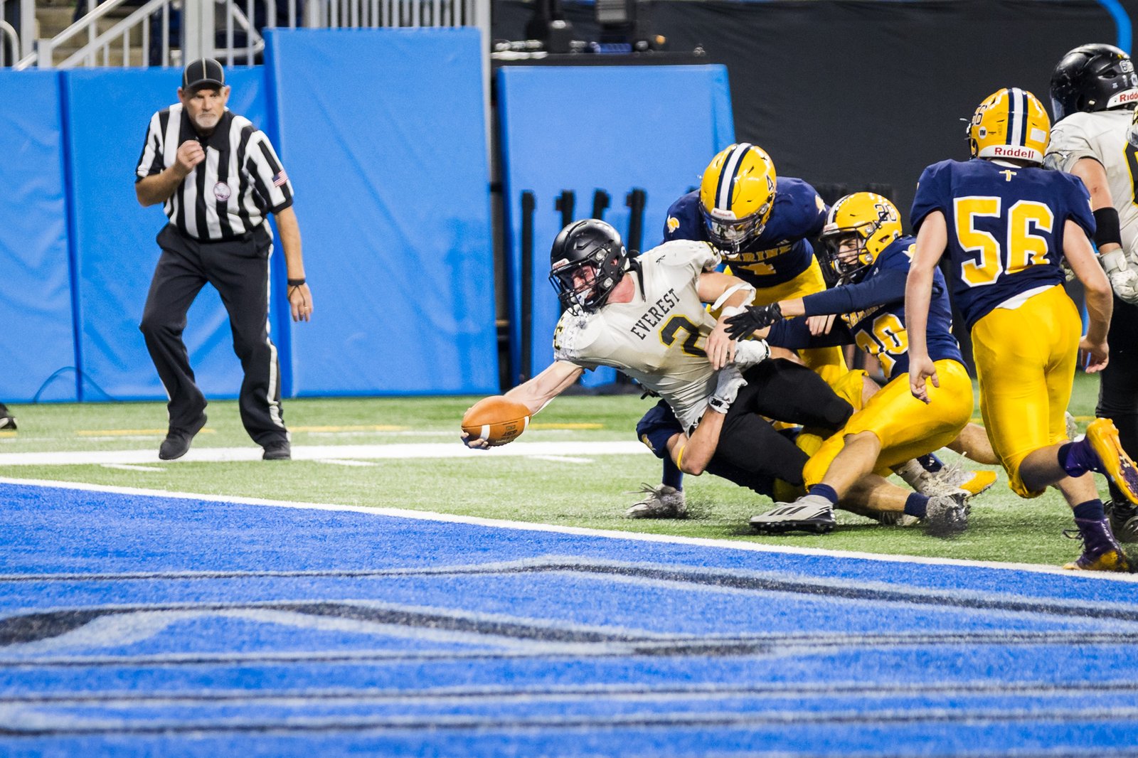 Everest senior running back Michael Gaglio crosses the goal line despite the efforts of three Shrine defenders in the CHSL Prep Bowl LIV Oct. 24 at Ford Field.  It was Everest’s fifth Prep Bowl victory in six appearances.