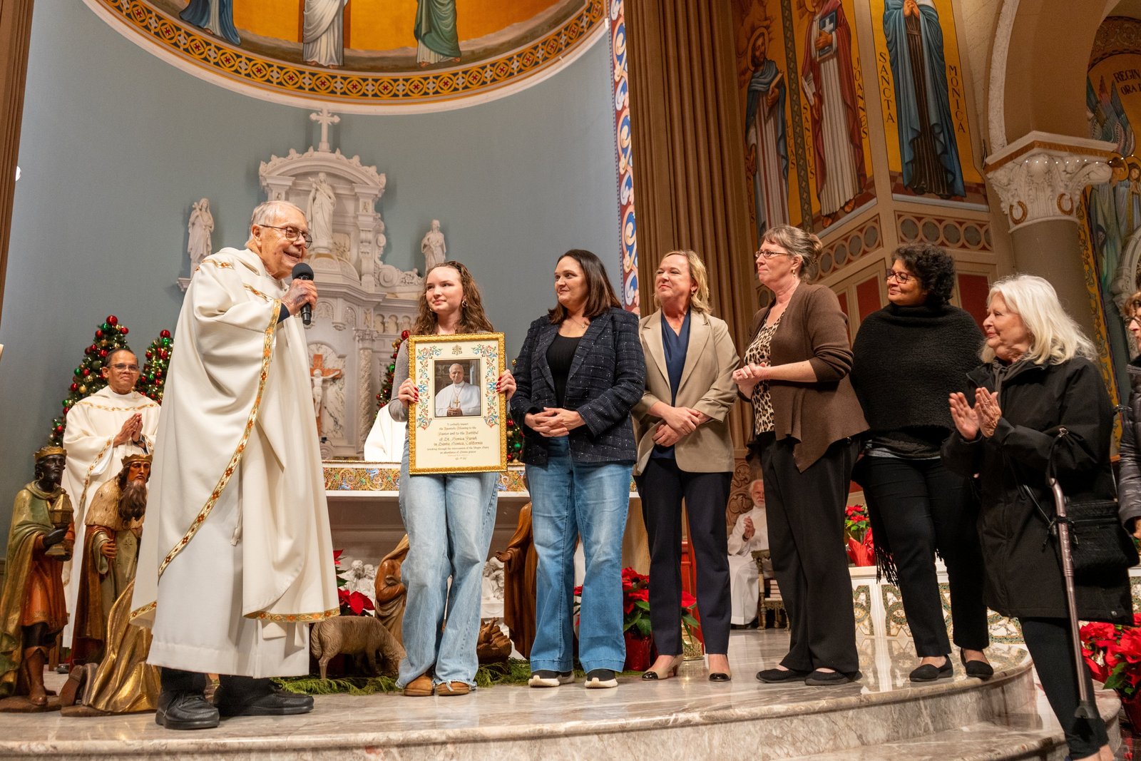 Msgr. Lloyd Torgerson and St. Monica parishioners are pictured Jan. 7, 2026, with a framed apostolic blessing from Pope Leo XIV obtained by Msgr. Liam Kidney, pastor of Corpus Christi Church in Pacific Palisades, Calif., as a sign of gratitude for their hospitality after the Palisades Fire. Corpus Christi Church was destroyed in the fire. (OSV News photo/Elizabeth Friedrich, courtesy Archdiocese of Los Angeles)