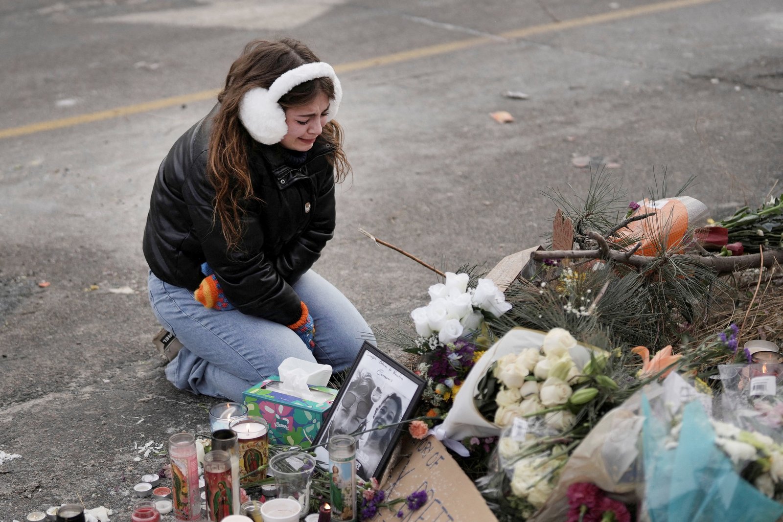 A young woman becomes emotional at a makeshift memorial in Minneapolis Jan. 25, 2026, at the site where a man was fatally shot by federal agents trying to detain him Jan. 24. Archbishop Bernard A. Hebda of St. Paul and Minneapolis, along with other Church leaders, have called for peace amid growing tensions. (OSV News photo/Tim Evans, Reuters)