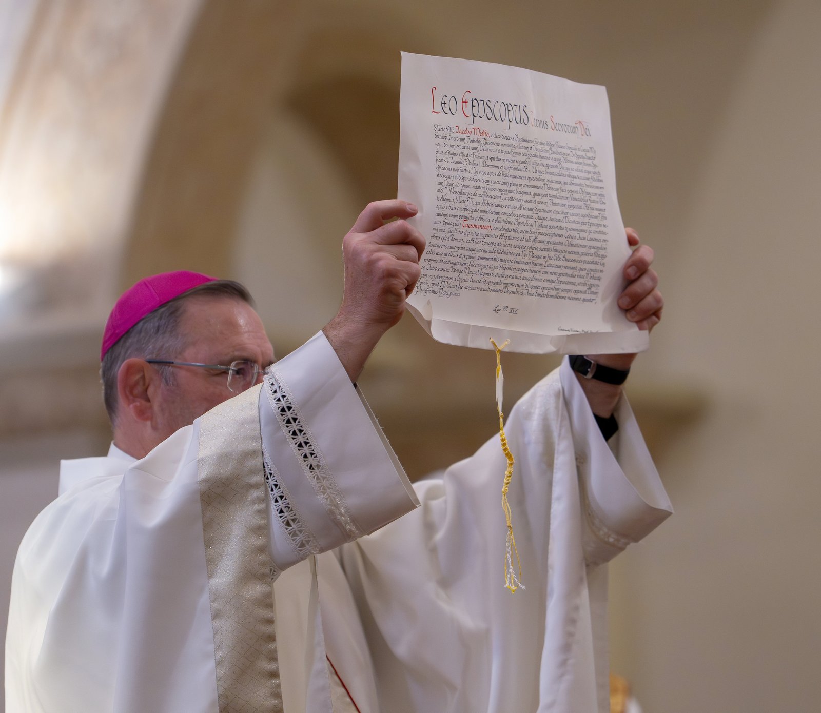 Newly ordained Bishop James A. Misko displays the papal bull on his episcopal appointment during his ordination and installation Mass as bishop of Tucson, Ariz., at St. Augustine Cathedral in Tucson Feb. 20, 2026.