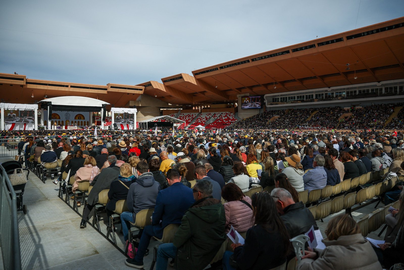 People attend a public Mass celebrated by Pope Leo XIV at the Louis II Stadium as part of his one-day trip in Monaco, March 28, 2026. (OSV News photo/Guglielmo Mangiapane, Reuters)