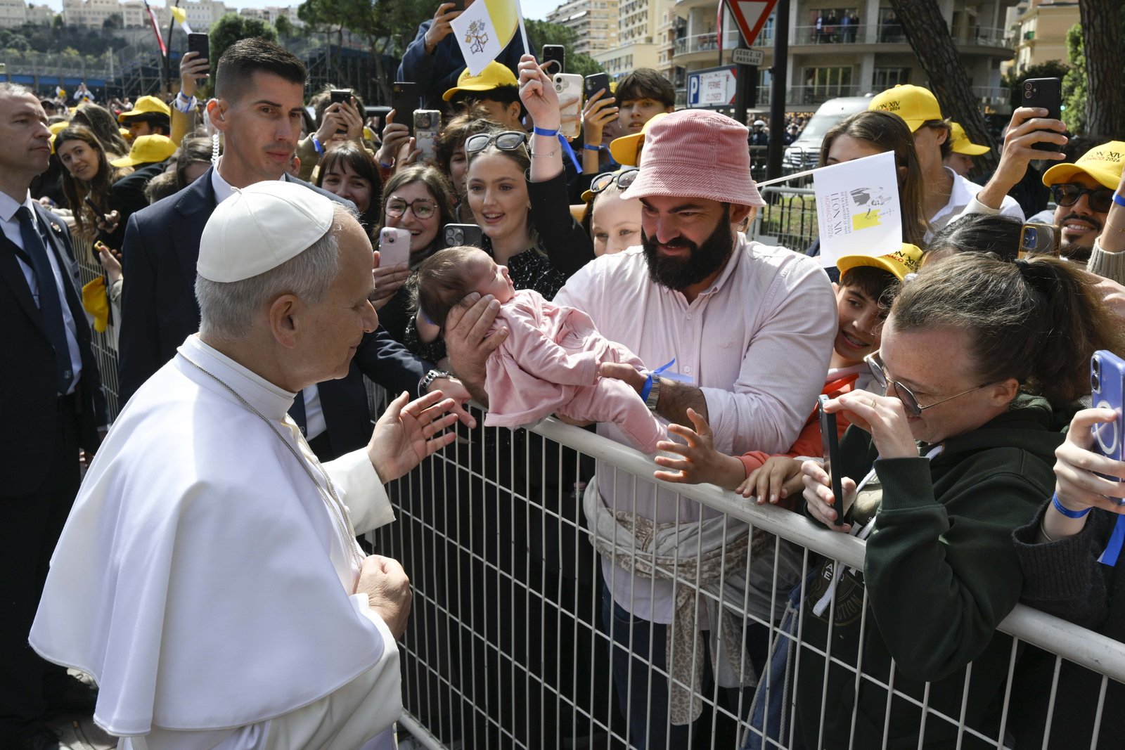 Pope Leo XIV greets a baby near the church of St. Devota, where the pope had a meeting with young people and catechumens, as part of a one-day apostolic trip in Monaco, March 28, 2026. It is Pope Leo's first international journey of 2026 and only the second of his pontificate. (OSV News photo/Simone Risoluti, Vatican Media)
