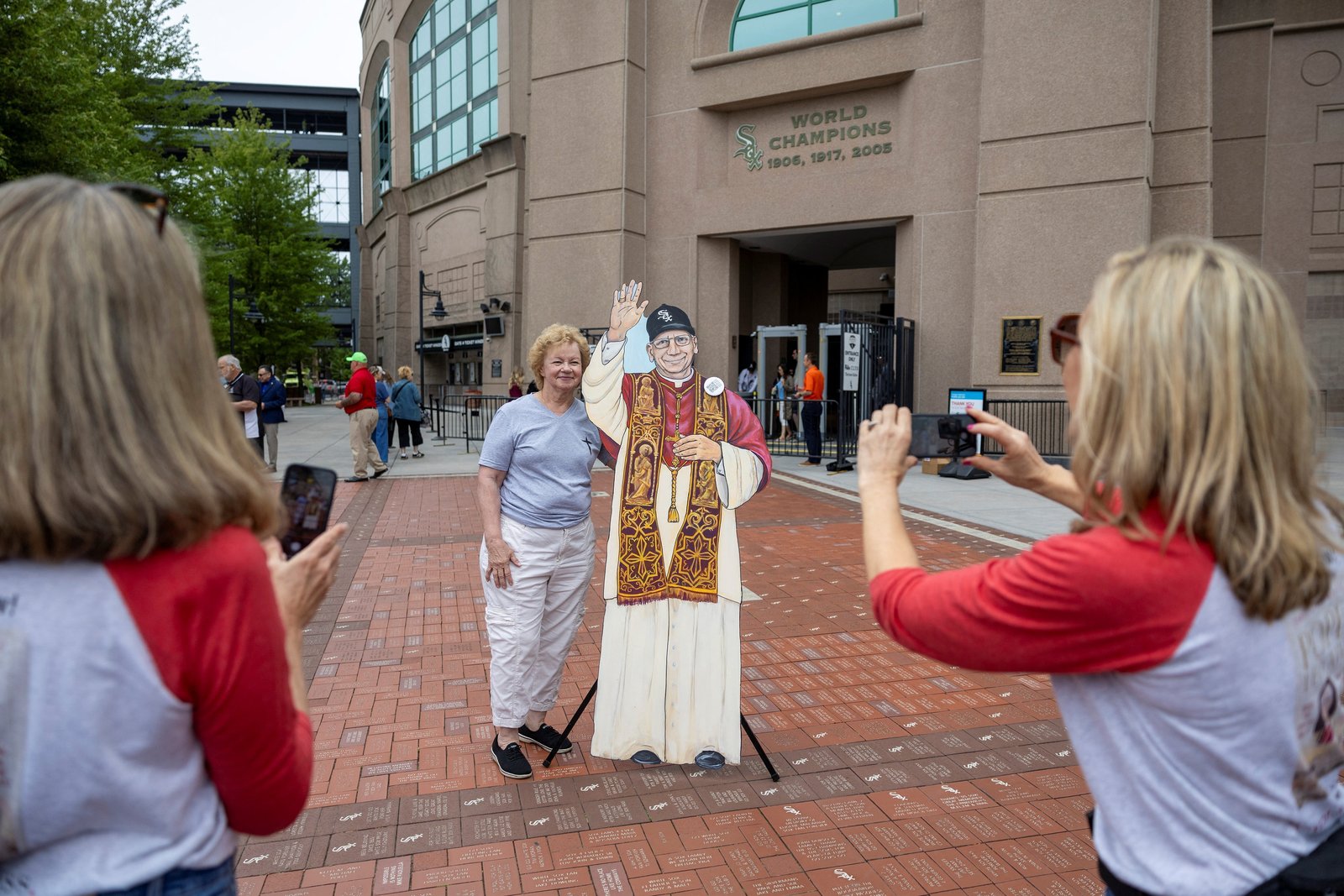 People take photos with a cardboard cutout of Pope Leo XIV ahead of a public celebration hosted by the Chicago White Sox and the Archdiocese of Chicago upon the election of the new pope, featuring a Mass at Rate Field in Chicago June 14, 2025. (OSV News photo/Carlos Osorio, via Reuters)