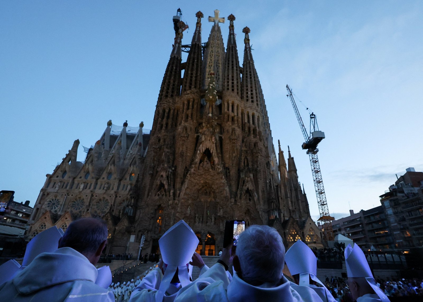 Members of the clergy stand outside the Basilica of the Sagrada Familia in Barcelona on the day of the inauguration and blessing of the Tower of Jesus Christ by Pope Leo XIV during his apostolic journey to Spain June 10, 2026. (OSV News photo/Nacho Doce, Reuters)