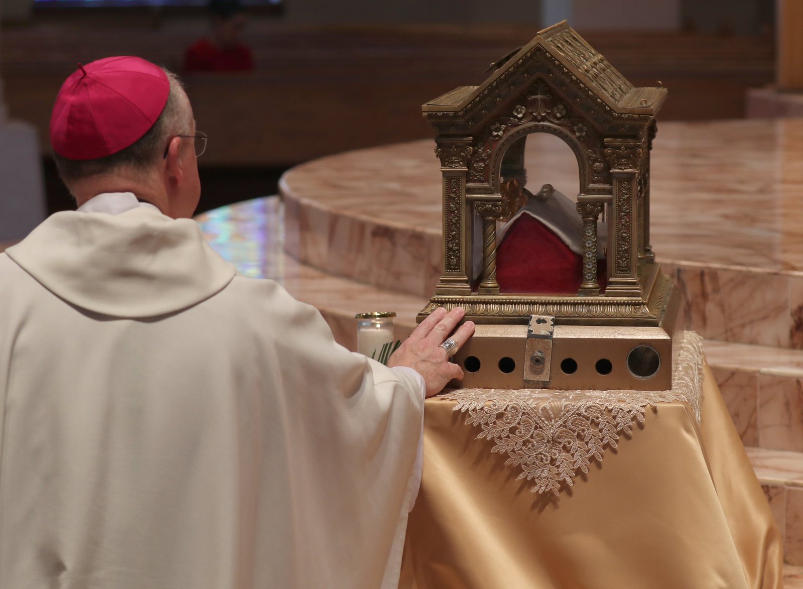 A prelate venerates a reliquary containing the relics of St. Margaret Mary Alacoque before the U.S. Catholic bishops consecrate the country to the Sacred Heart of Jesus at the Basilica of Mary Queen of the Universe in Orlando, Fla., June 11, 2026, during their spring plenary assembly. (OSV News photo/Bob Roller)