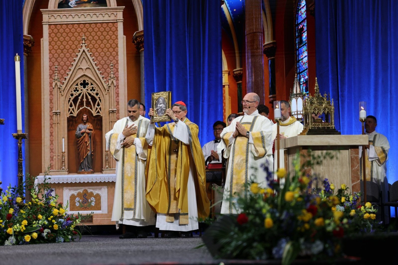 Cardinal Luis Tagle, pro-prefect of the Dicastery for Evangelization, elevates the book of the Gospels at the beatification Mass for Blessed Fulton J. Sheen held Sept. 24, 2026, at The Dome at America's Center in St. Louis. (OSV News photo/Margaret Murray)