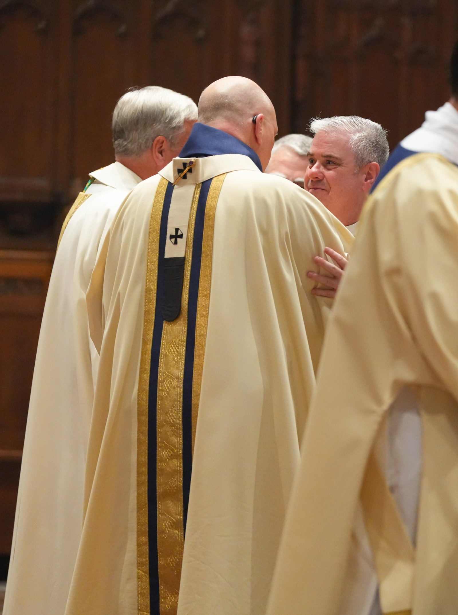 Detroit Archbishop Edward J. Weisenburger embraces Fr. Creagh during his installation Mass.