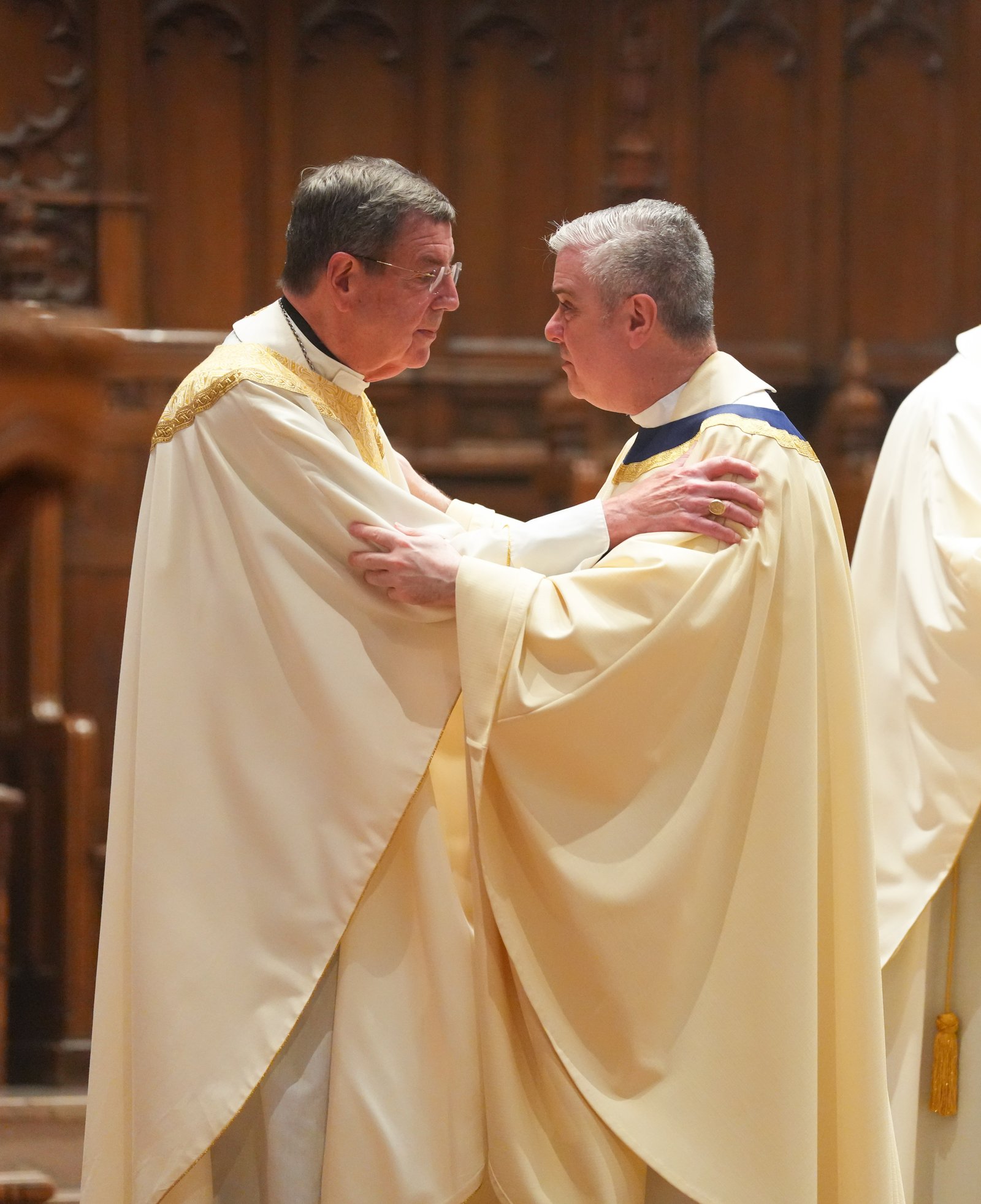 Detroit Archbishop-emeritus Allen H. Vigneron, who served as Sacred Heart's rector from 1994 to 2003, embraces Fr. Creagh.