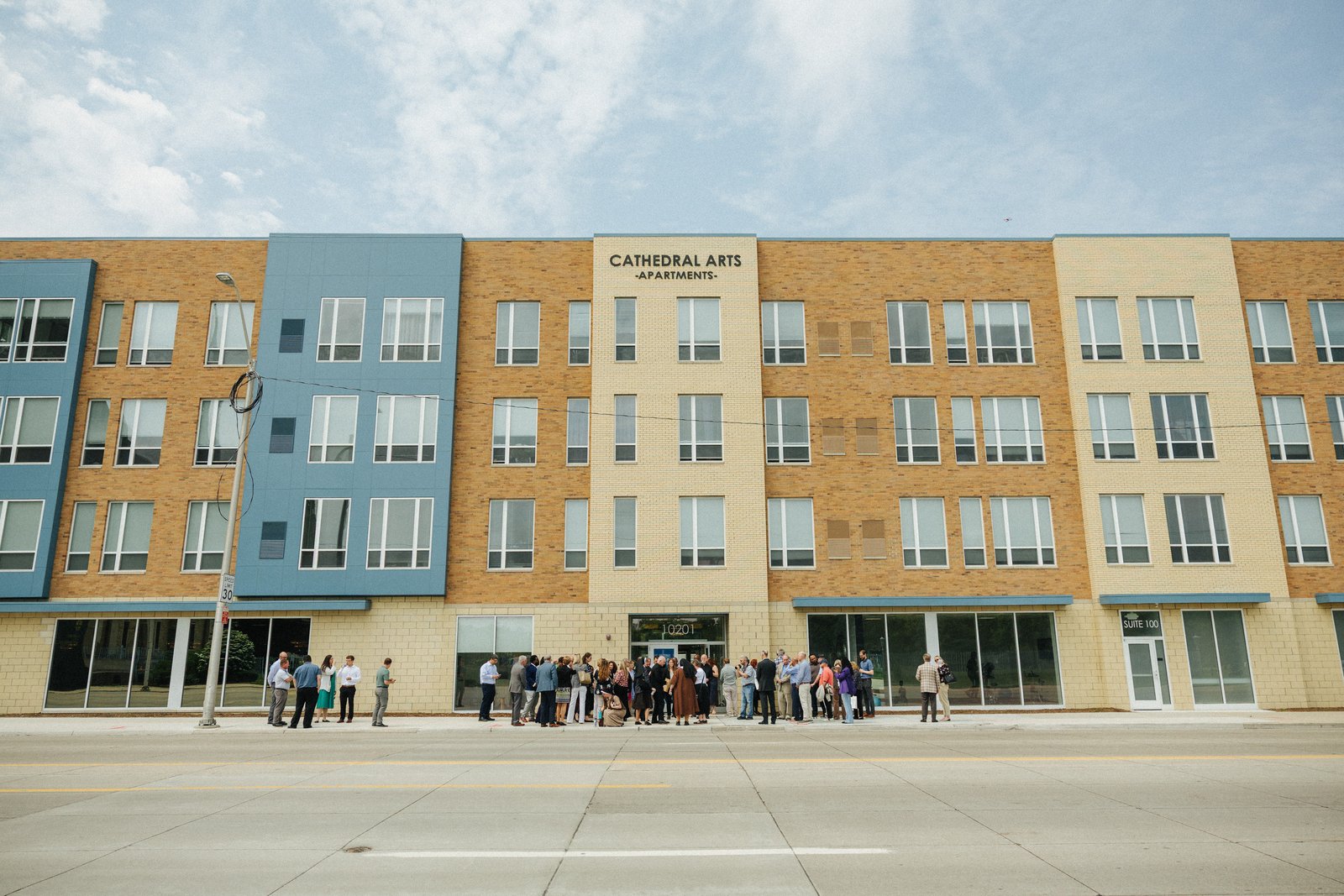 Civic, community and religious leaders gather for the ribbon-cutting of the new Cathedral Arts Apartments across the street from the Cathedral of the Most Blessed Sacrament. The new development brings 53 units of affordable housing to Detroit's North End neighborhood, along with an M Training Center workforce development initiative. (Photo courtesy of the City of Detroit)