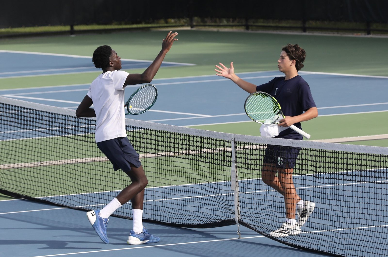 Country Day’s Samuel Kole-James and Cranbrook’s Trevor Ilitch congratulate each other following their championship match at No. 2 singles. Kole-James won in three sets, 3-6, 6-1, 6-2.