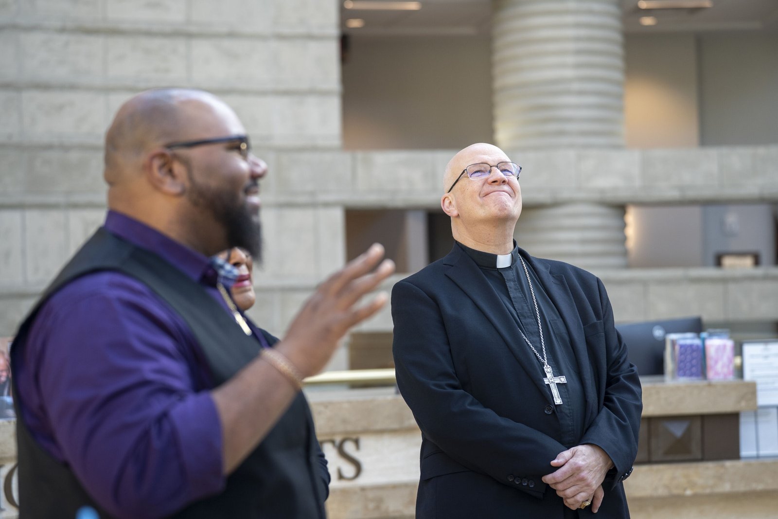 Archbishop Weisenburger gazes up at the state-of-the-art, 12,500-square-foot Charles H. Wright Museum of African American History as tour guide Jonathan Jones explains the museum's history and mission.