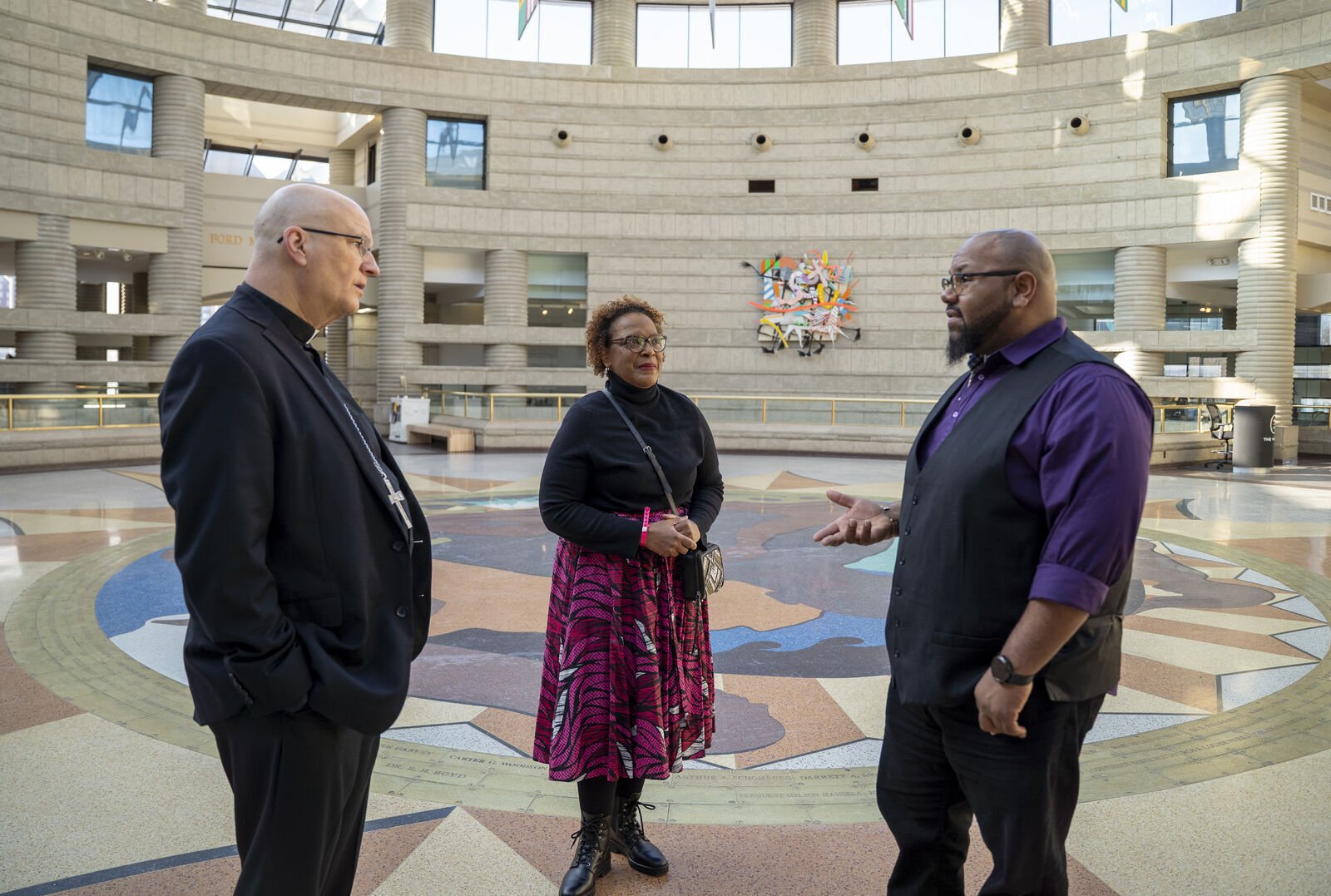 Jonathan Jones, right, manager of youth and family programs at the Charles H. Wright Museum of African American History in Detroit's Midtown, speaks with Archbishop Edward J. Weisenburger and Vickie Figueroa, associate director for cultural ministries and coordinator of Black Catholic ministry in the Archdiocese of Detroit, during a tour of the museum on Feb. 8.
