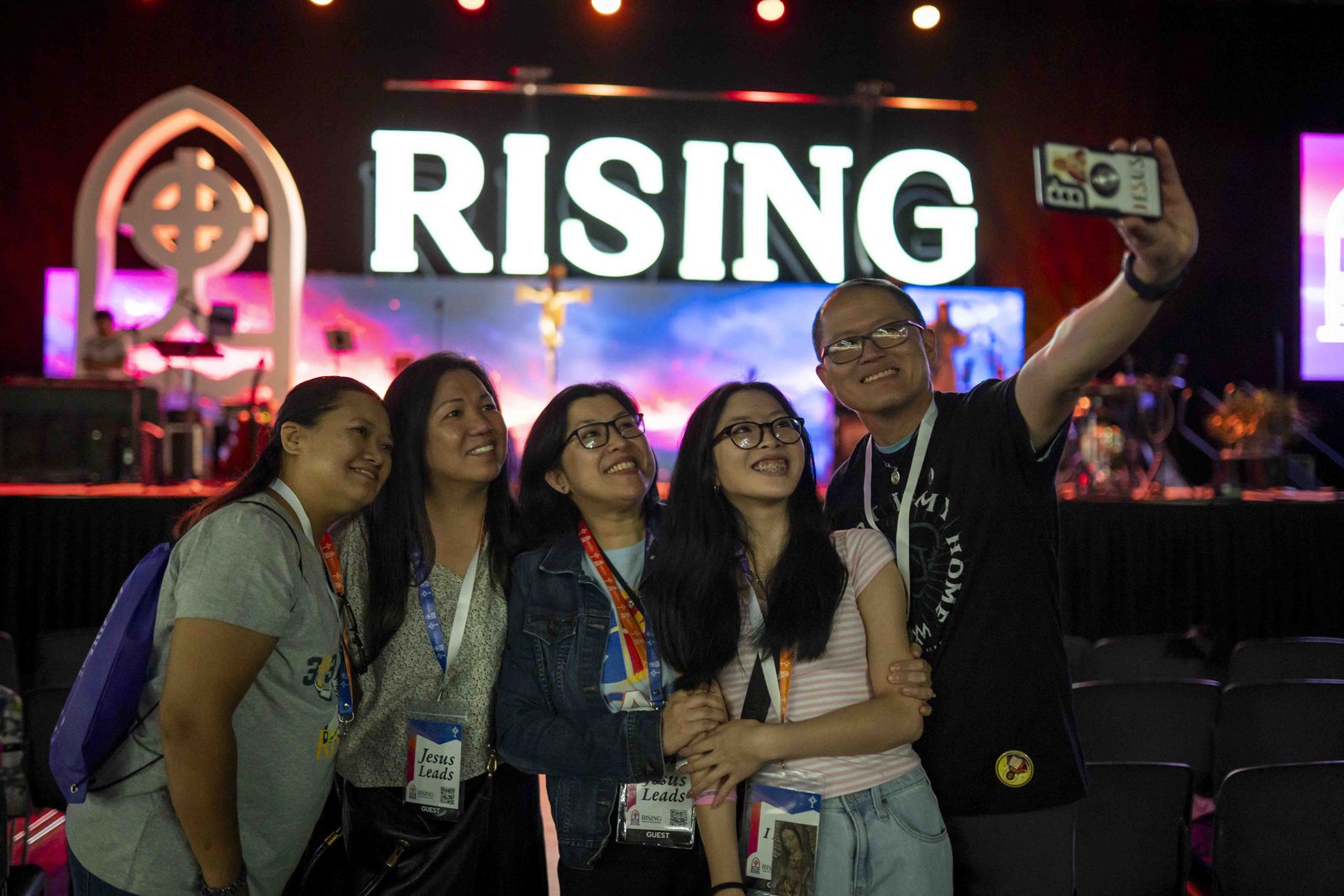 Catholics pose for a photo in front of the stage during the inaugural "Rising from the Ashes" Revival on July 22 at Huntington Place in downtown Detroit. (Valaurian Waller | Special to Detroit Catholic)