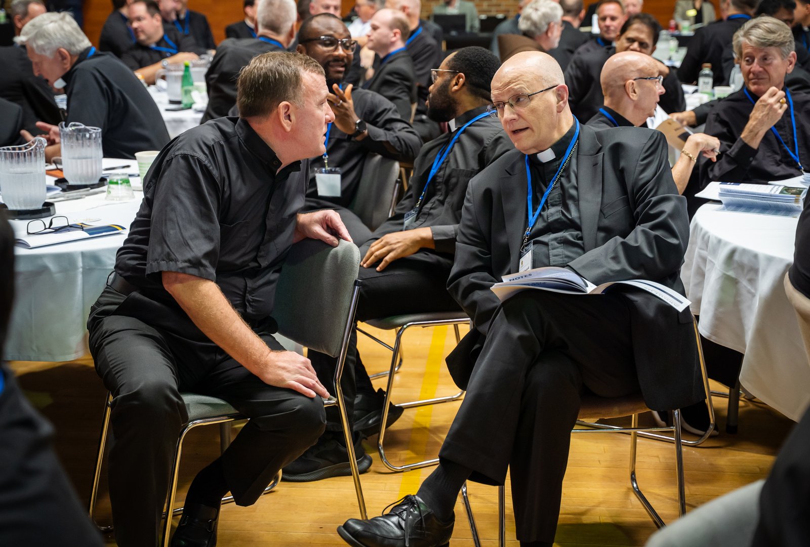 Archbishop Edward J. Weisenburger, right, speaks with priests during a Sept. 1 meeting at Sacred Heart Major Seminary to talk about the archdiocesan restructuring process. The archbishop encouraged priests to pray for and with one another, and pledged the support of archdiocesan leaders throughout the difficult conversations ahead.