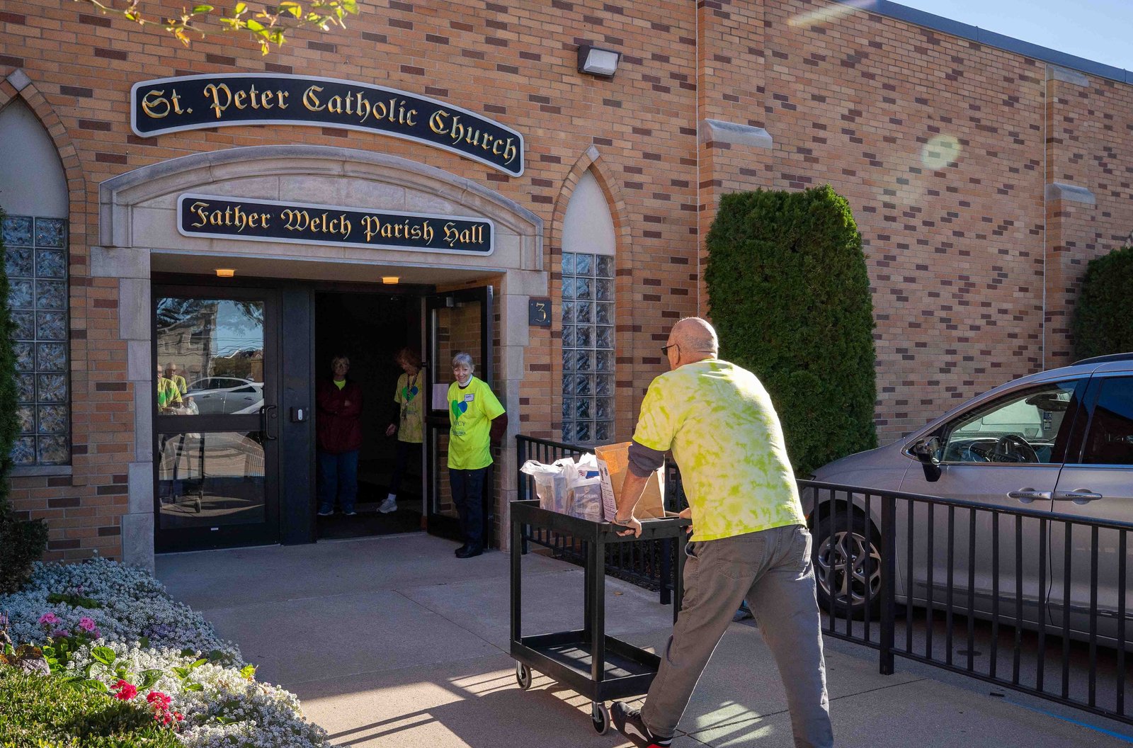 Volunteers deliver curbside donations into the parish hall, where they'll be sorted and donated to various local causes. (Valaurian Waller | Detroit Catholic)
