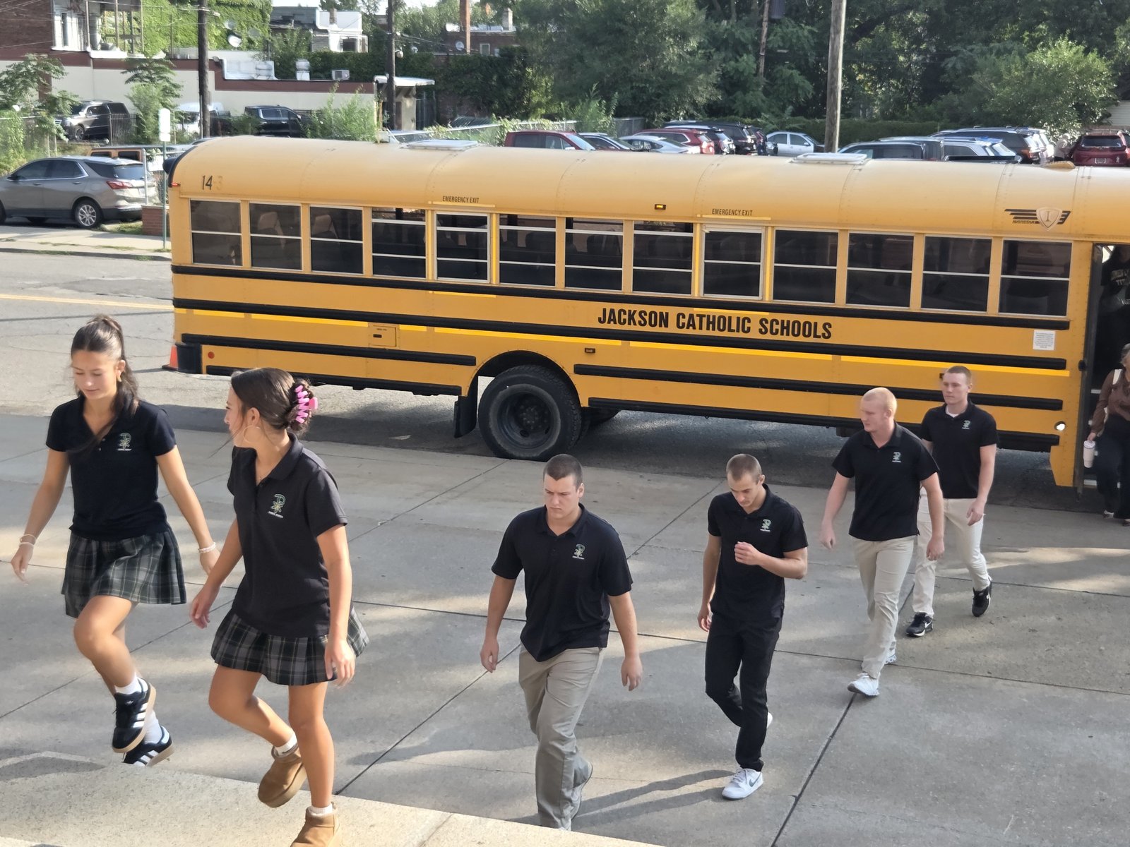 Catholic League member high schools from far and wide attended the centennial Mass. Here, students from Lumen Christi Catholic High School in Jackson disembark from their bus after arriving at Holy Redeemer.