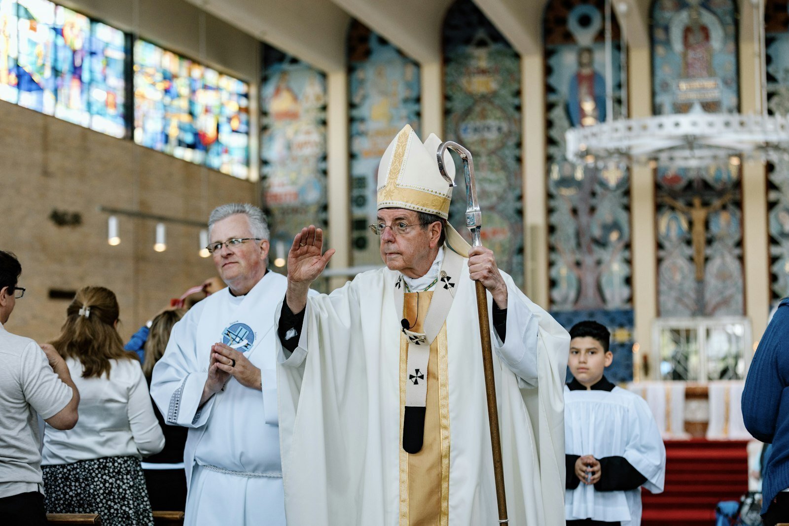 Archbishop Allen H. Vigneron blesses the congregation as he processes out following Mass at St. Scholastica Parish on June 1. (Alissa Tuttle | Special to Detroit Catholic)