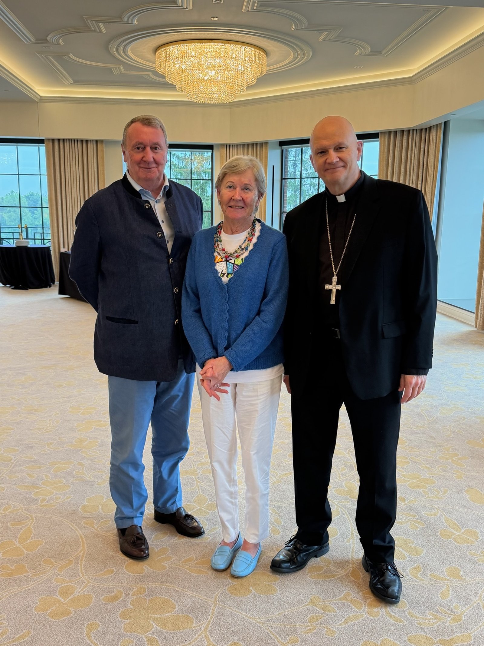 Archbishop Weisenburger greets a couple came from Belgium during the event. In his earlier years, Archbishop Weisenburger studied in Belgium from 1983 to 1987, and quickly found common topics of conversation.