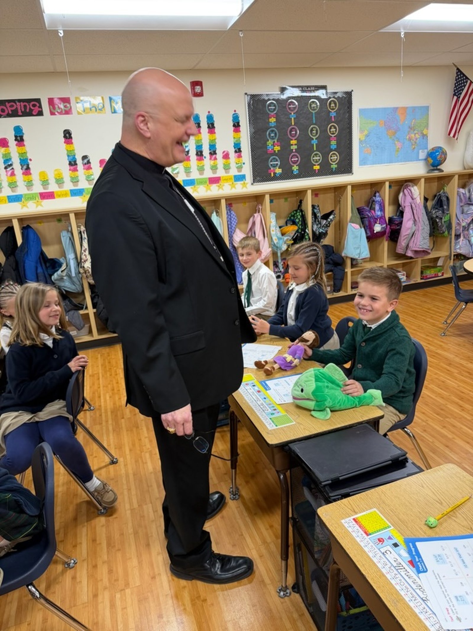 Archbishop Weisenburger chats with a "young theologian" who shows the archbishop his stuffed Jonah and the whale figures.