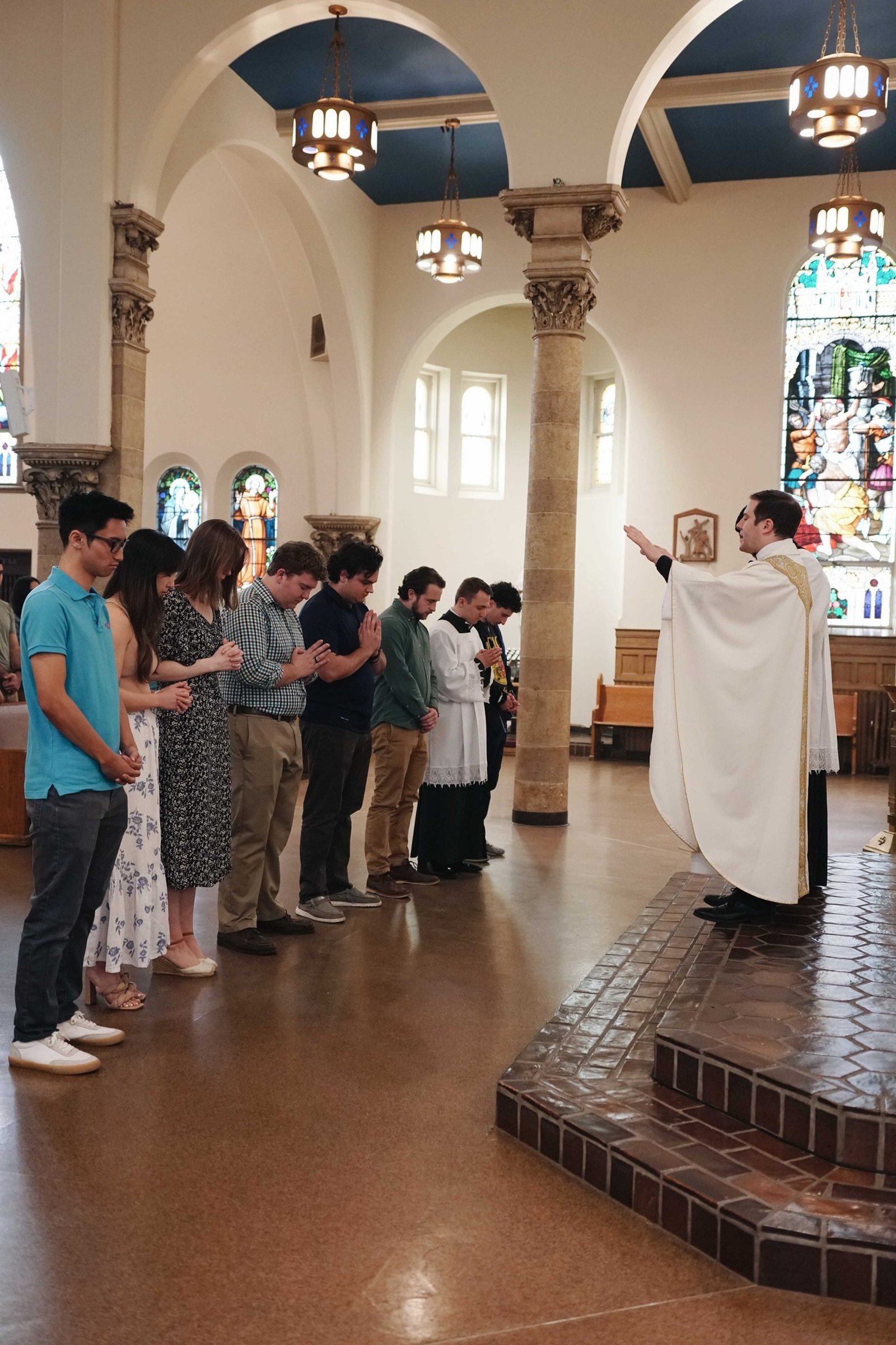 Fr. Matthew Hood blesses young men at Our Lady of the Rosary Church in Detroit, which serves as a home base for Catholic students at Wayne State University.