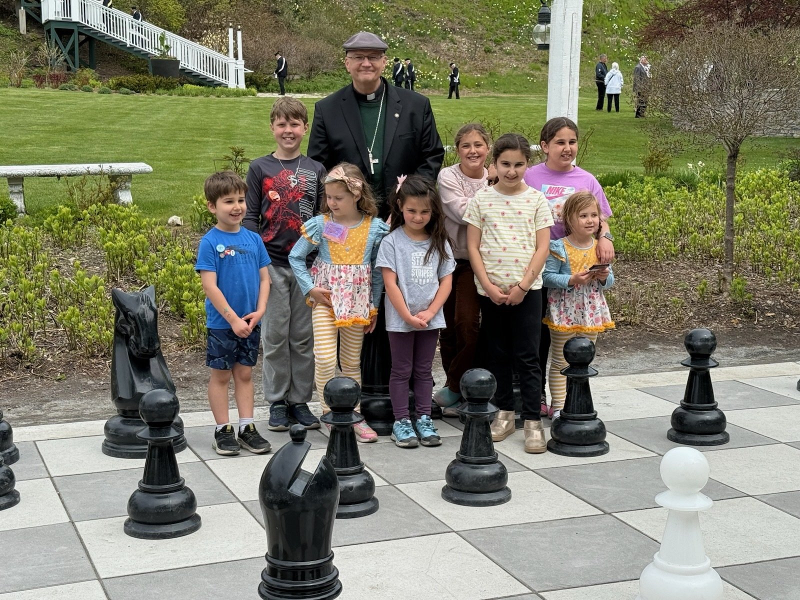 At the outdoor chess board, Archbishop Weisenburger was taught that eight pawns CAN take a bishop!