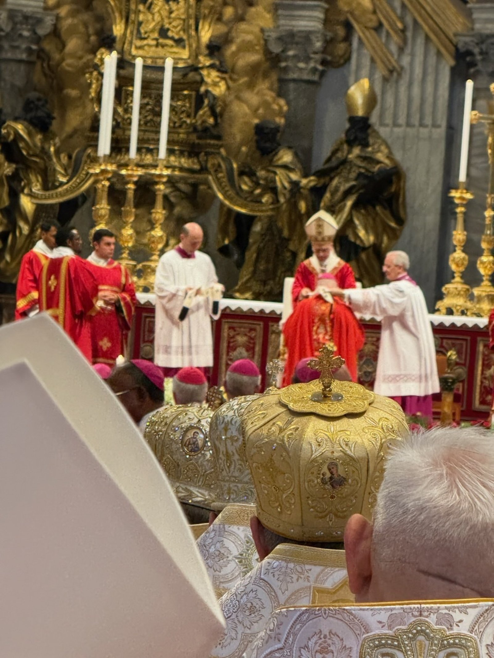 Pope Leo imposes the pallium upon the shoulders of Archbishop Weisenburger, who was among dozens of newly appointed archbishops from around the world to gather in Rome for the Mass.