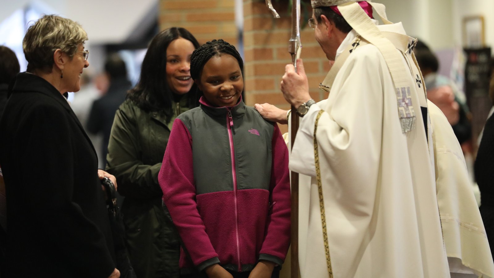 Archbishop Vigneron greets a young parishioner at St. Fabian Parish in Farmington Hills during a visit to the parish April 15, 2018. (Naomi Vrazo | Detroit Catholic file photo)