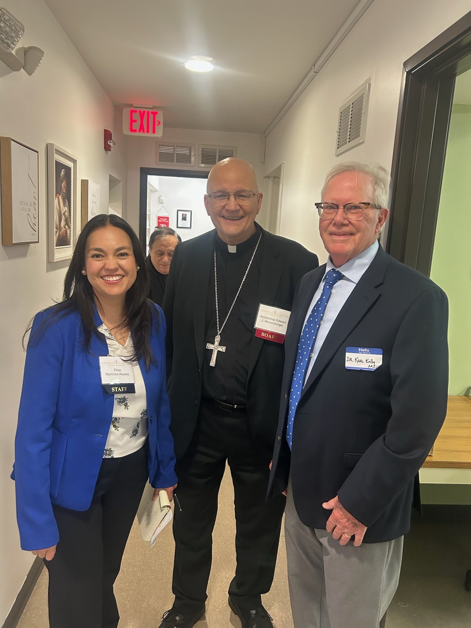 Archbishop Weisenburger is pictured with Cabrini Clinic executive director Elisa Martinez-Alvarez, left, and Dr. Karl Kolbe, the clinic's volunteer medical director.