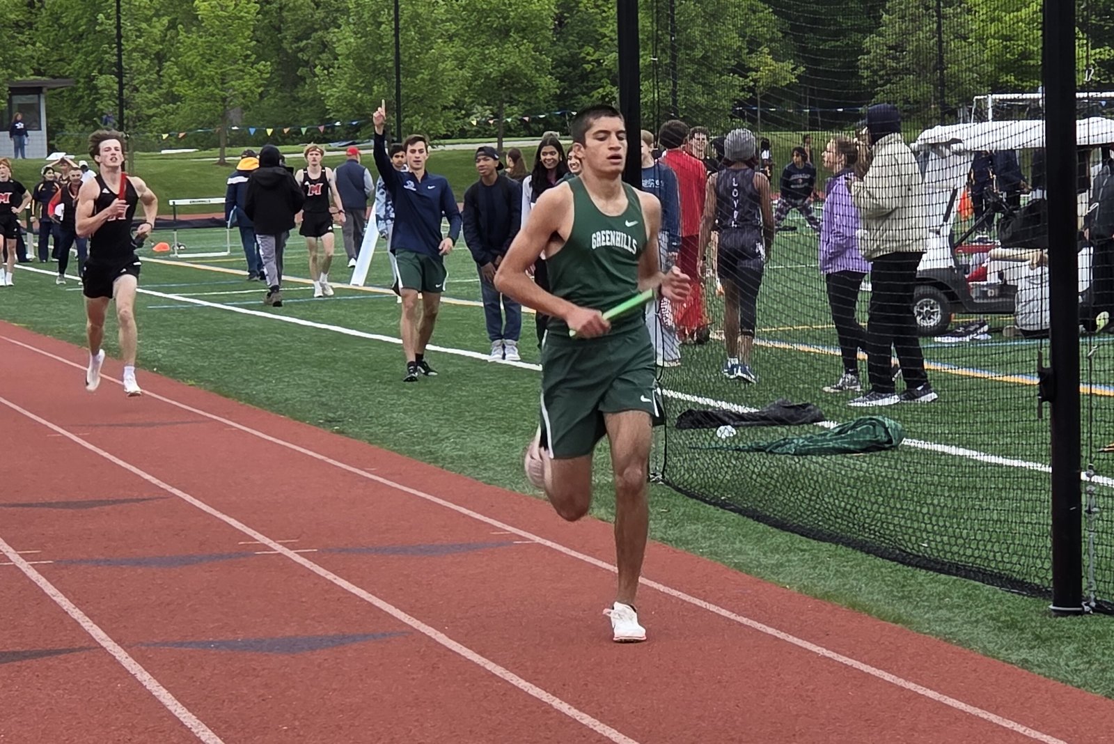 Naveen Kulkarni brings the baton home in first place in the boys’ 4x800 meter relay at the Catholic League St. Anne Division track meet on May 20. Ann Arbor Greenhills won the event in 8:48.63, three seconds better than Marine City Cardinal Mooney.