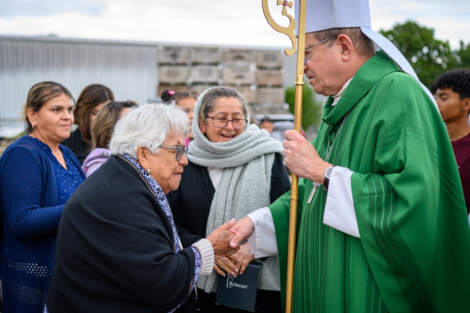 Bishop David J. Walkowiak of the Diocese of Grand Rapids speaks with immigrants as part of a Mass for Migrants the bishop celebrates annually.