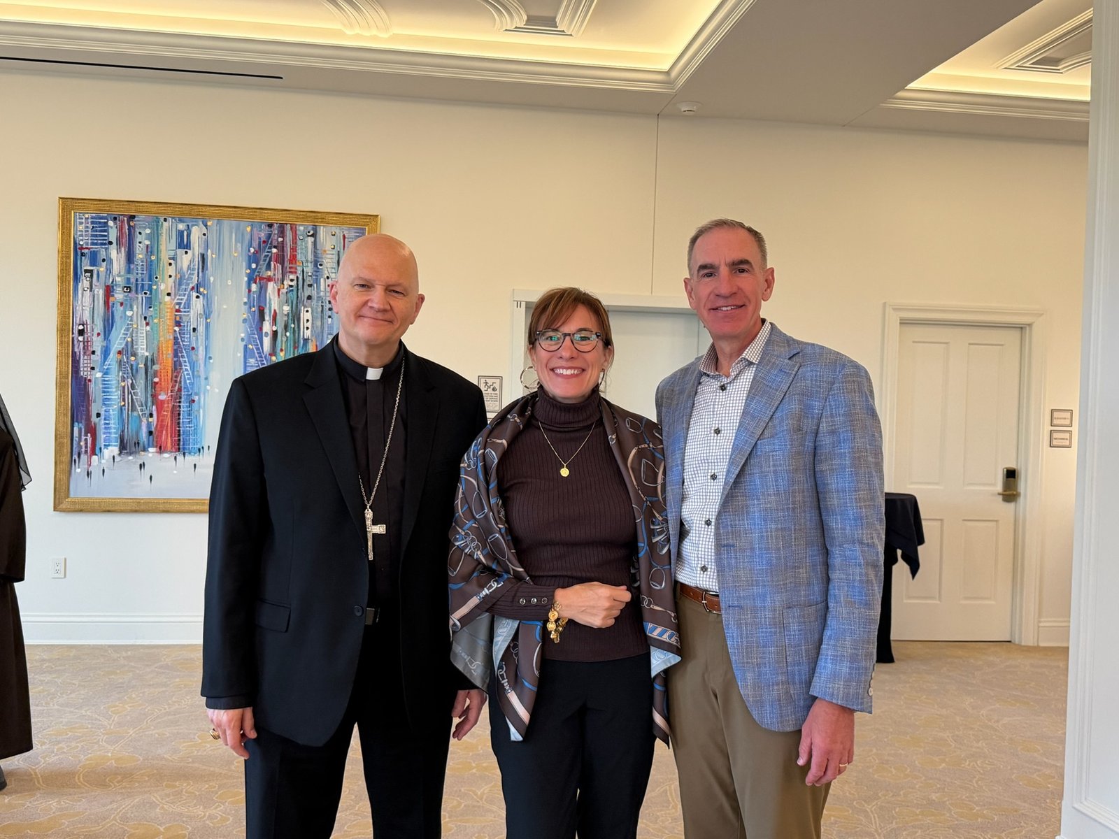 Archbishop Weisenburger is pictured with John and Kristan Hale, leaders of the Michigan Chapter of the Patrons of the Arts in the Vatican Museums, who hosted the event at St. John's Resort.