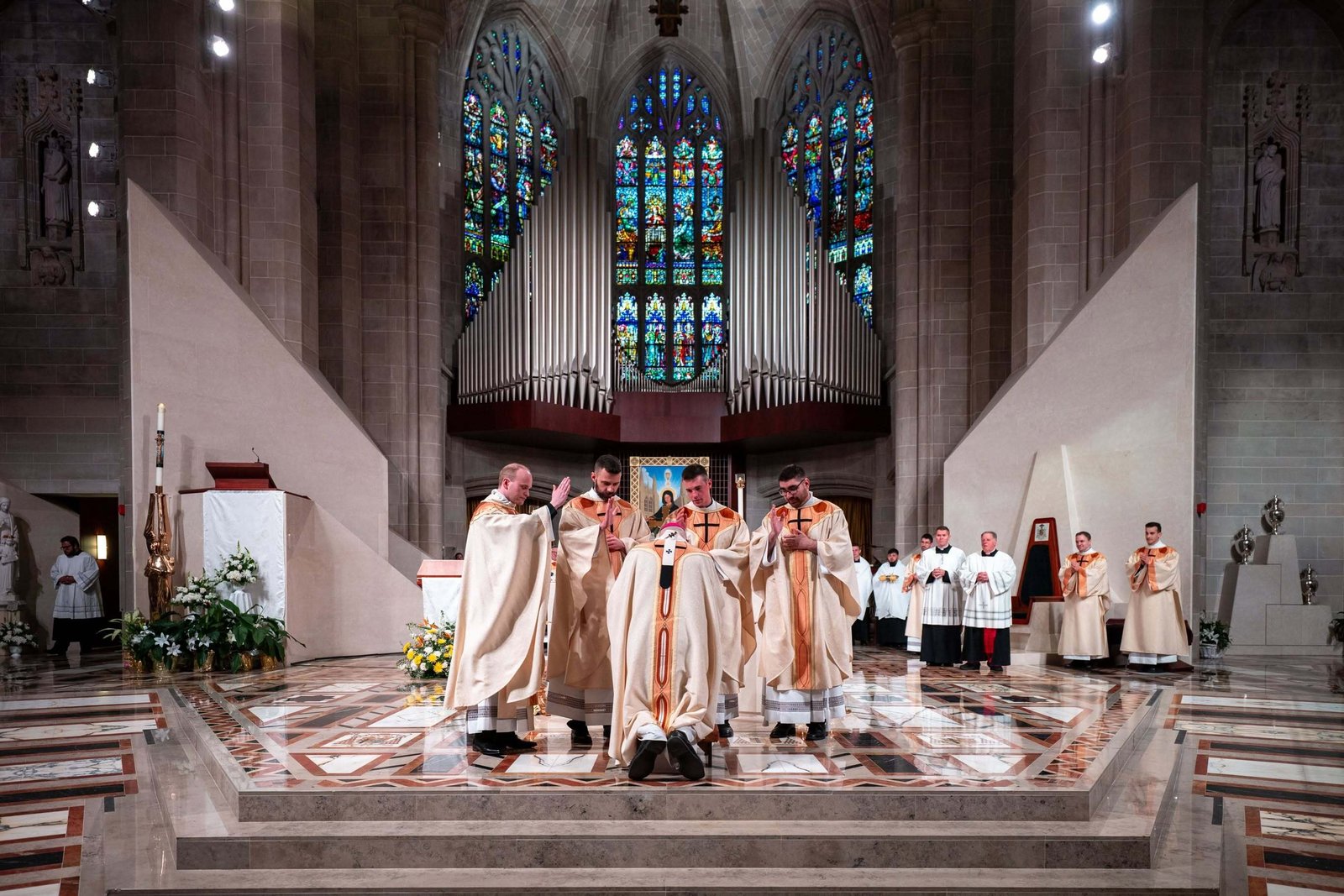 The four new priests offer their first priestly blessing upon Detroit Archbishop Edward J. Weisenburger as part of the ordination rite on May 23 at the Cathedral of the Most Blessed Sacrament in Detroit. (Tim Fuller | Special to Detroit Catholic)