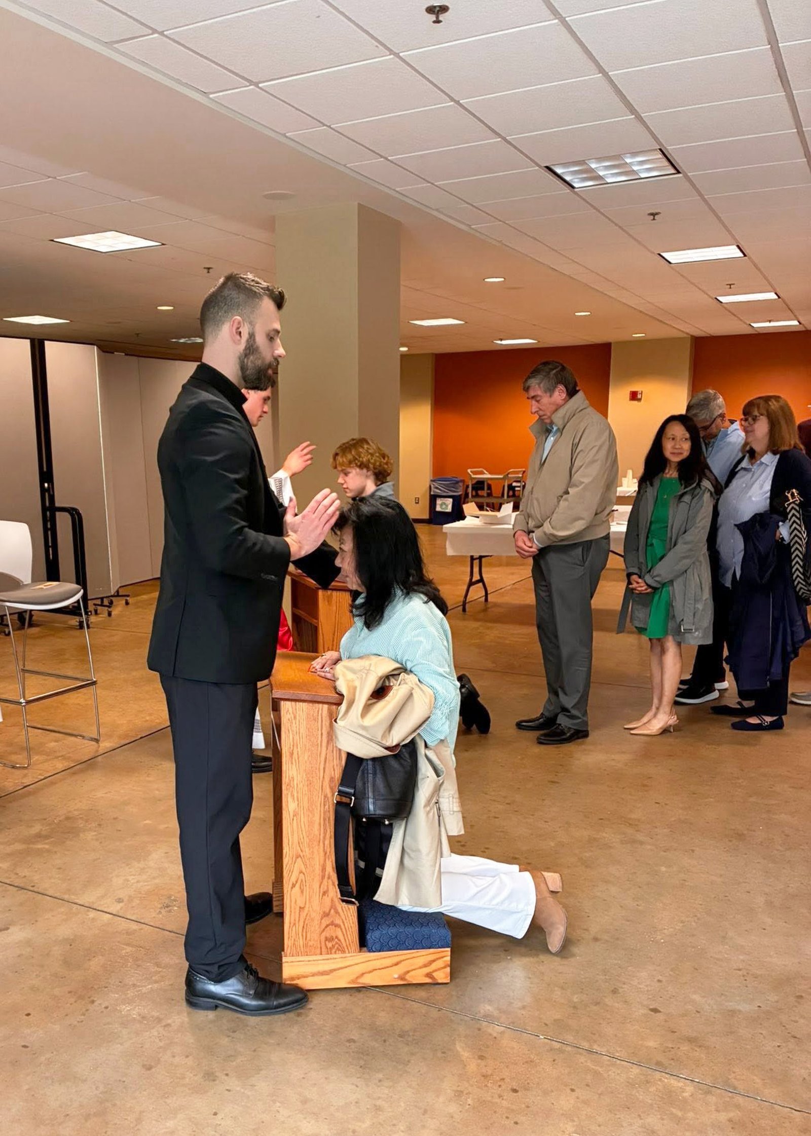 Fr. James Musgrave and Fr. Karl Finkbeiner bless parishioners following a Mass of thanksgiving at Our Lady of Good Counsel Parish in Plymouth, where both priests attended as parishioners prior to their ordination. (Photo courtesy of Michelle Piccolo)