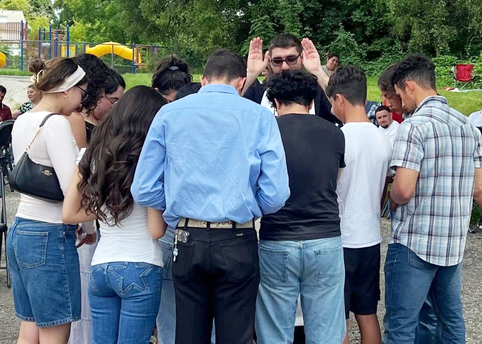Fr. Lizadro Barba blesses a group of young people following Mass at St. Damien of Molokai Parish in Pontiac. (Photo via St. Damien of Molokai Parish's Facebook page)