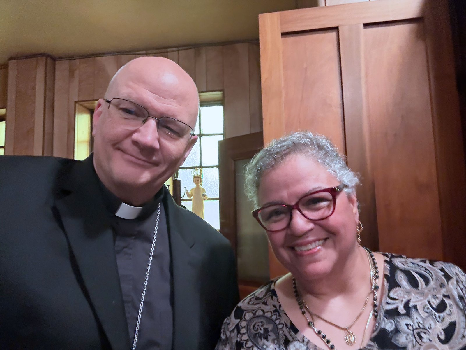 Archbishop Weisenburger takes a "selfie" with Candice Betke, sacristan at St. John Paul II Parish, before Mass.