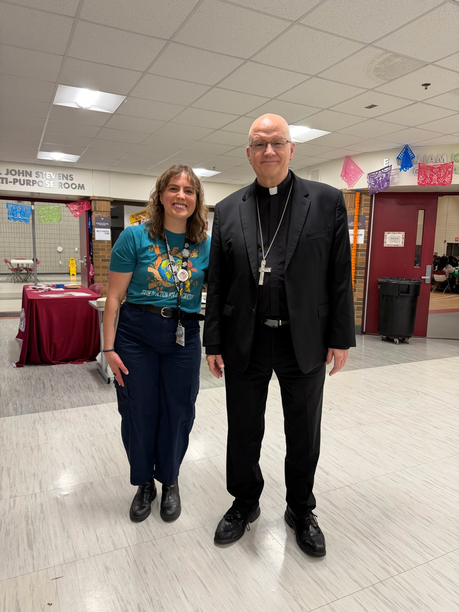 Archbishop Weisenburger with University of Detroit Jesuit campus minister Hannah Coley.