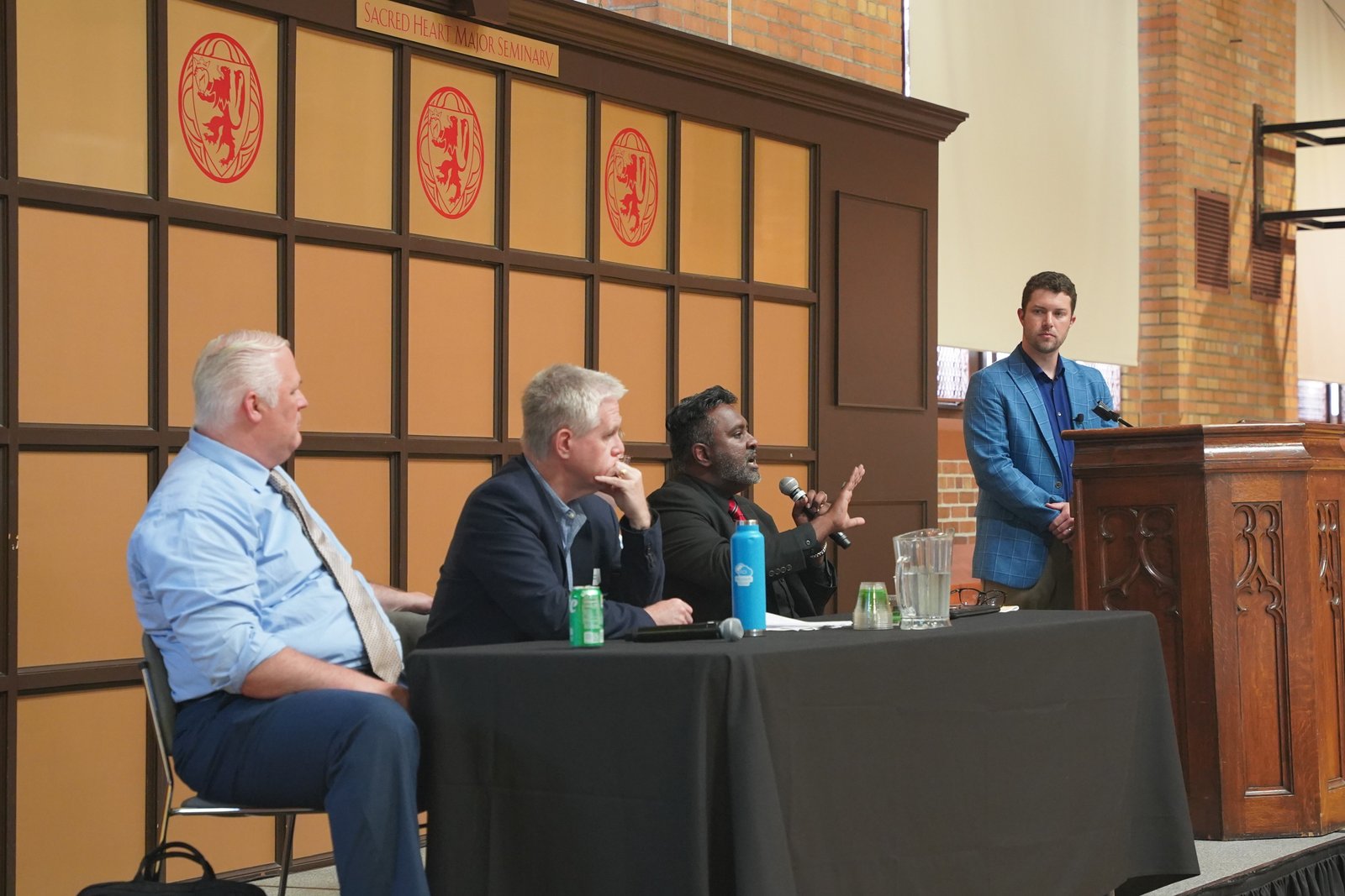 John Brahier, right, director of partnerships at Longbeard, moderates a panel discussion featuring (left to right) Darren O'Brien, a licensed psychologist and mental health professional; Brendan Newell, principal engineer at Microsoft who specializes in cybersecurity for AI; and Marcus Peter, Ph.D., director of theology for Ave Maria Radio and the Kresta Institute.