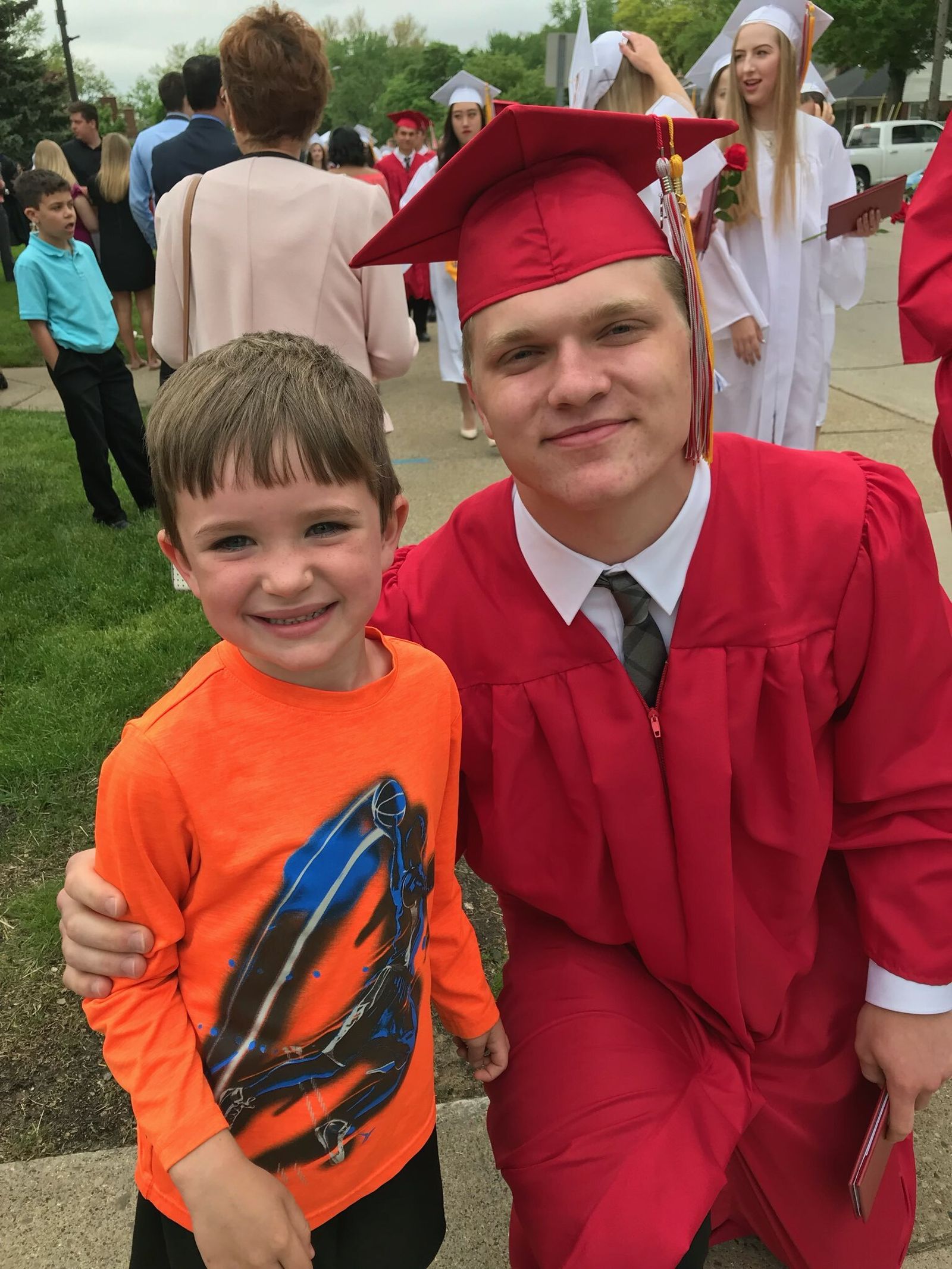 Aidan Hutchinson at his Divine Child graduation with Niall Laney, Chris Laney's son. Chris said Aidan maintains close contact with the Divine Child community, and frequently asks Laney for updates on the Falcons. (Courtesy of Chris Laney)