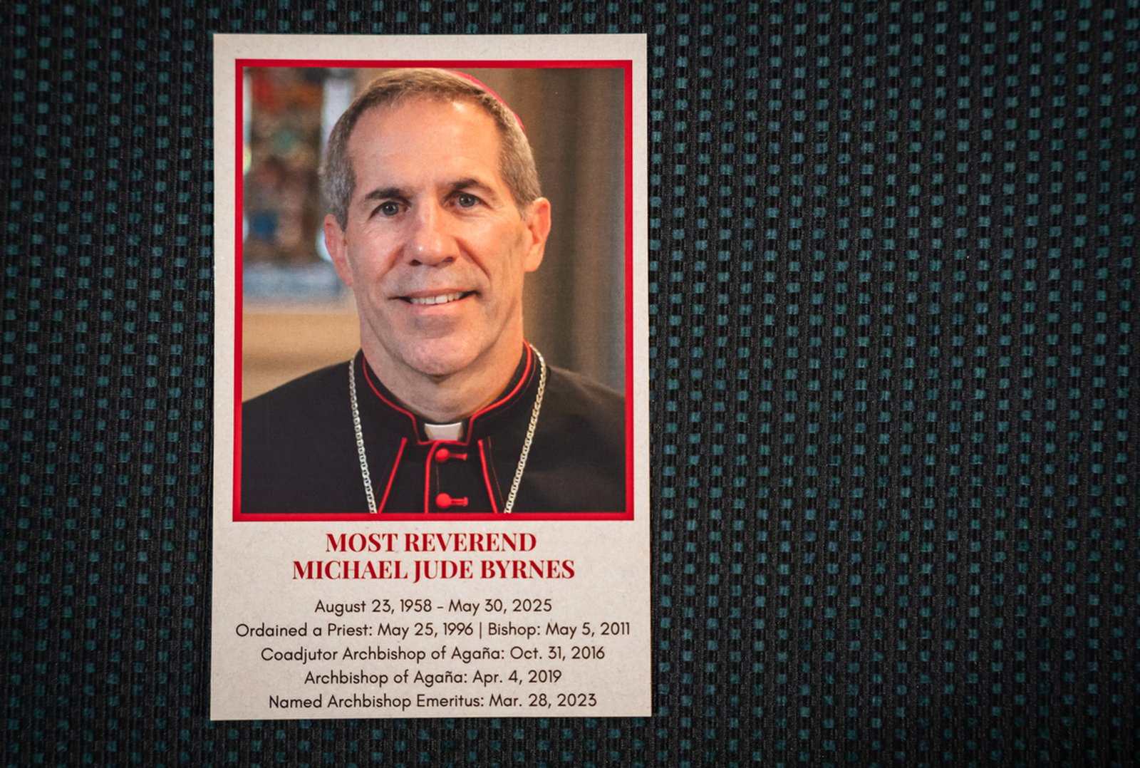 A funeral card for Archbishop Michael J. Byrnes is seen on a pew during the funeral Mass.