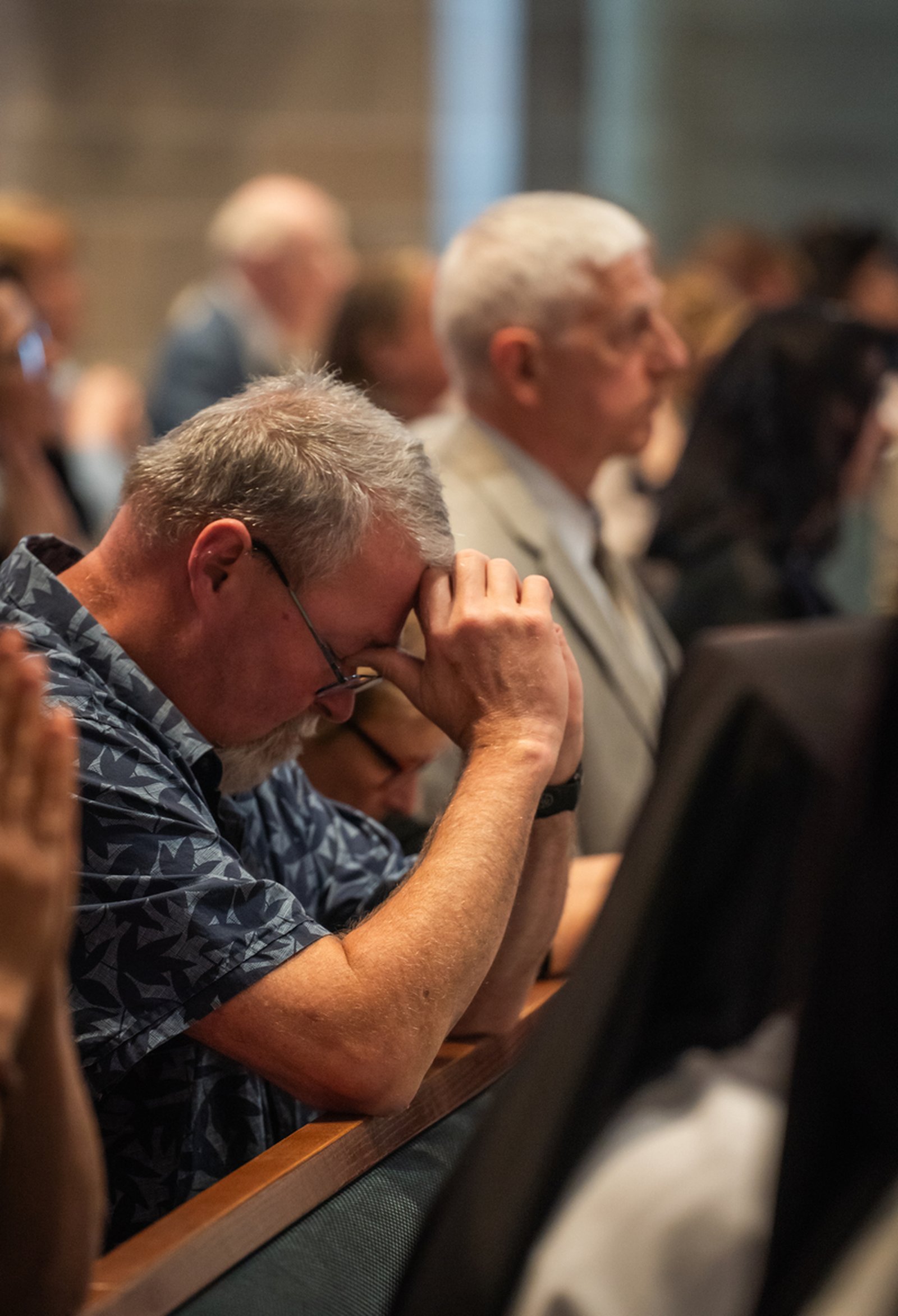 Mourners pray for the repose of Archbishop Michael J. Byrnes during the funeral liturgy. The archbishop's belief in the gifts and mission of the laity came through in each of his assignments, Fr. Riccardo said.