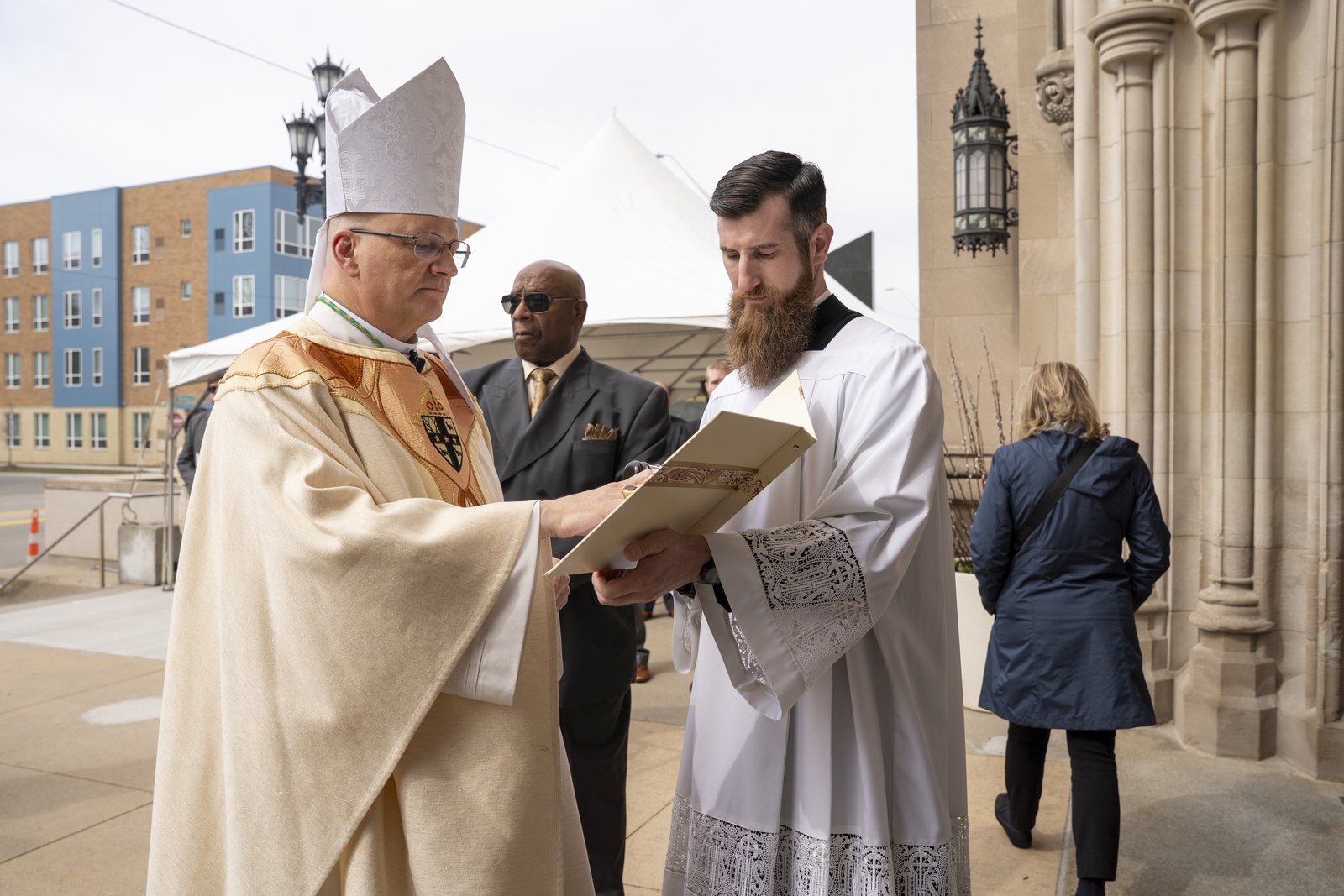 Archbishop Weisenburger prepares to knock on the cathedral's doors as Fr. Derik Peterman assists as the start of the rite of installation March 18 at the Cathedral of the Most Blessed Sacrament. (Valaurian Waller | Detroit Catholic)